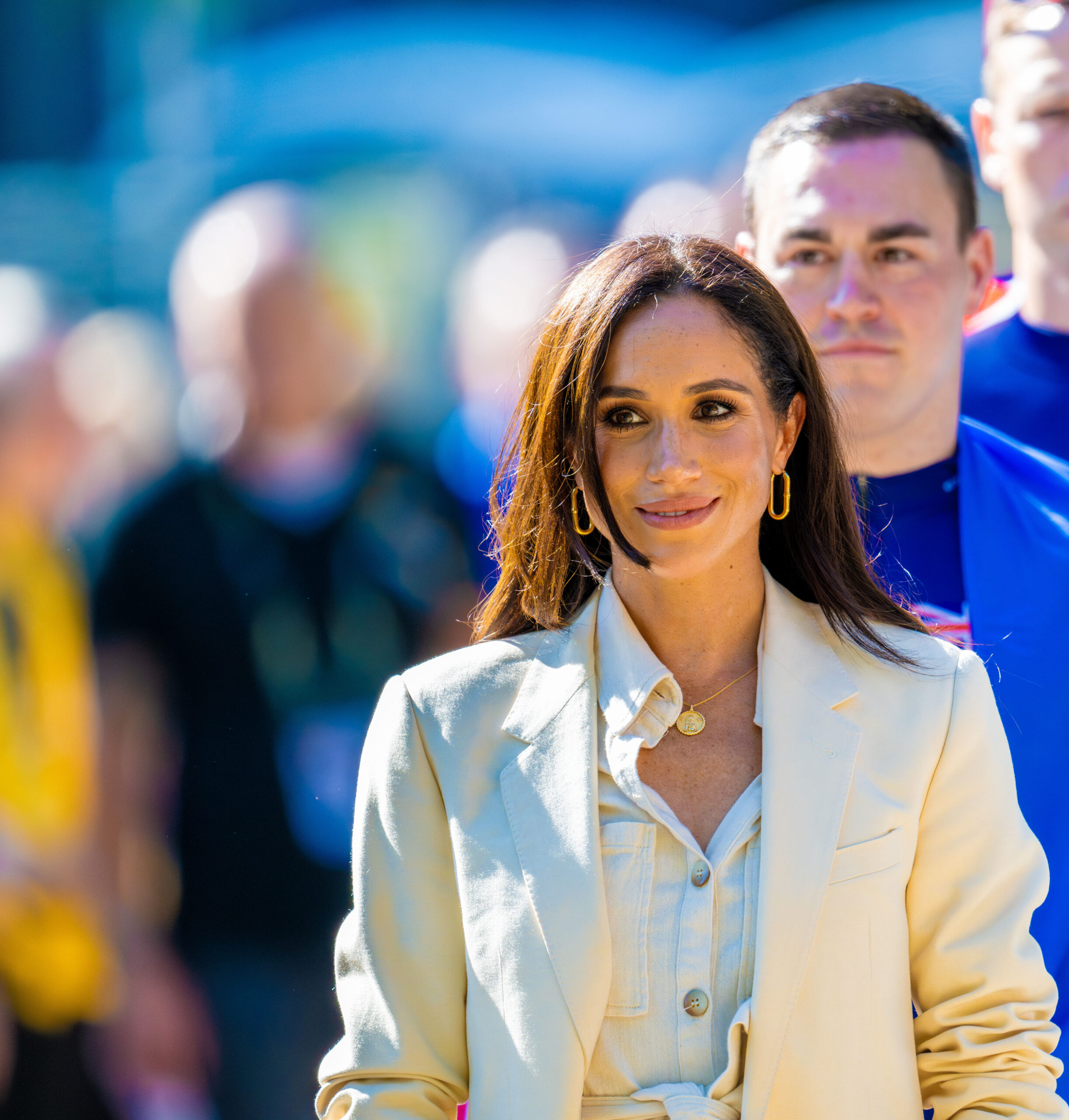 Meghan Markle smiling and looking to the side 