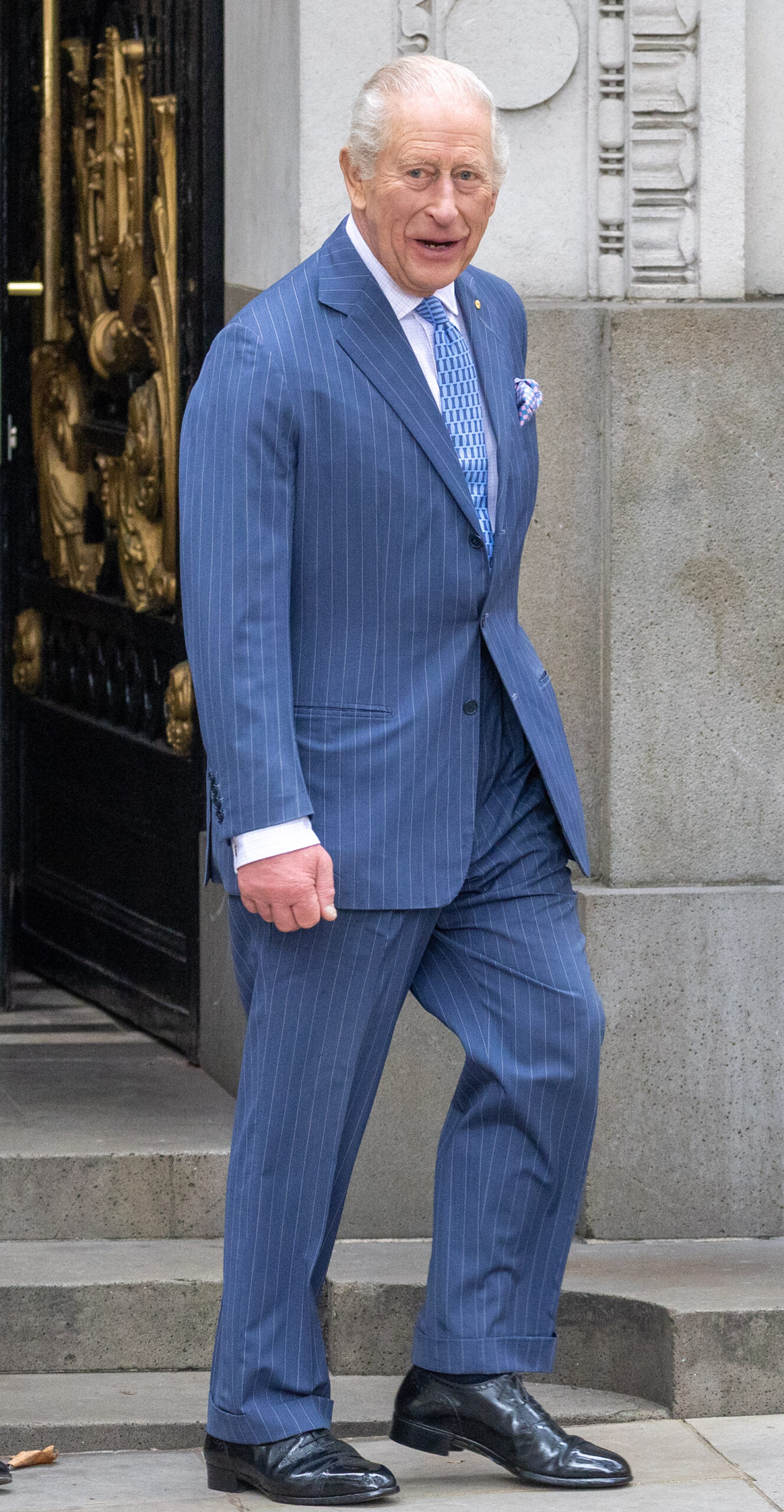 King Charles walking and looking at camera
