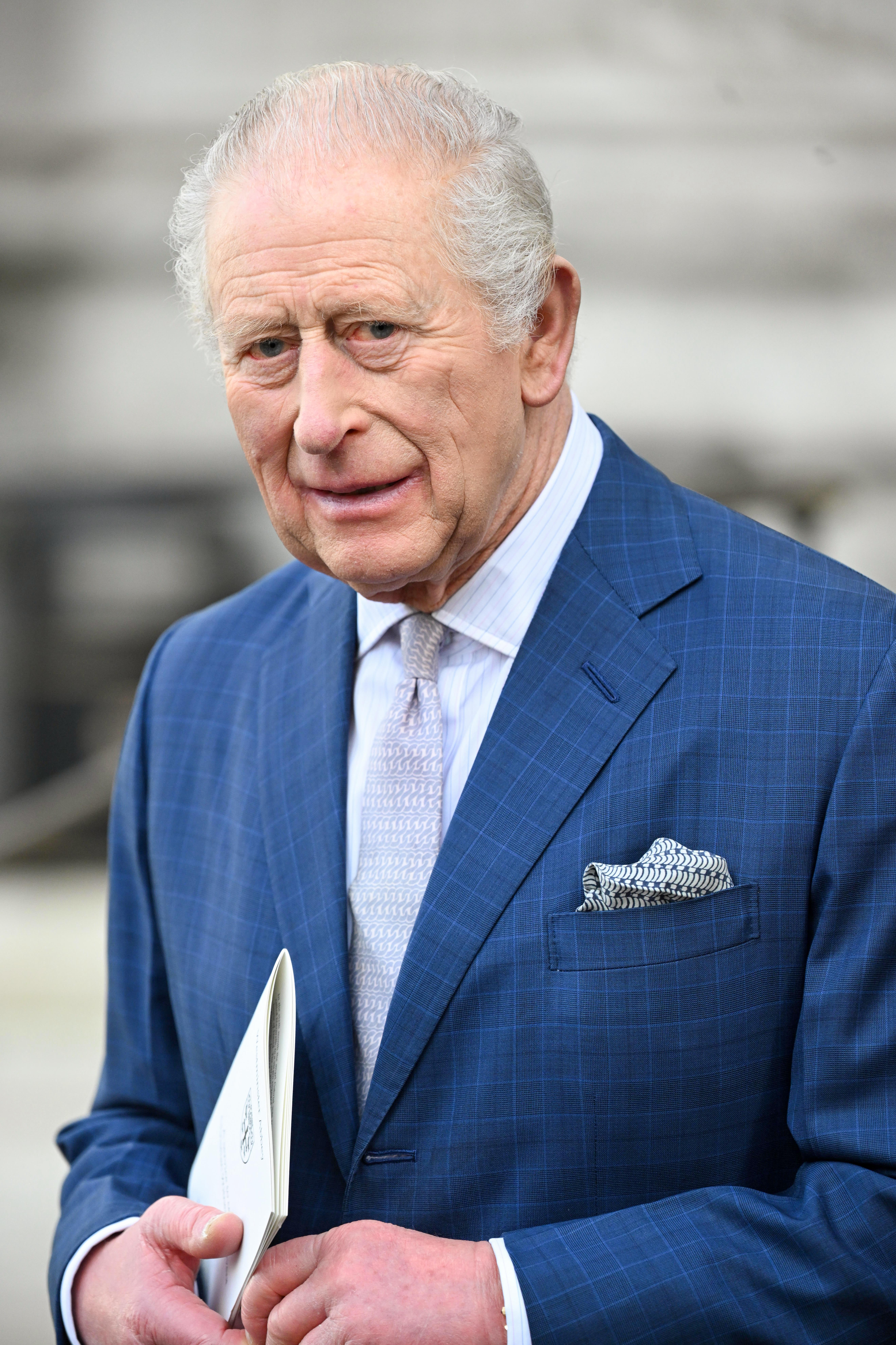 King Charles wearing a navy suit