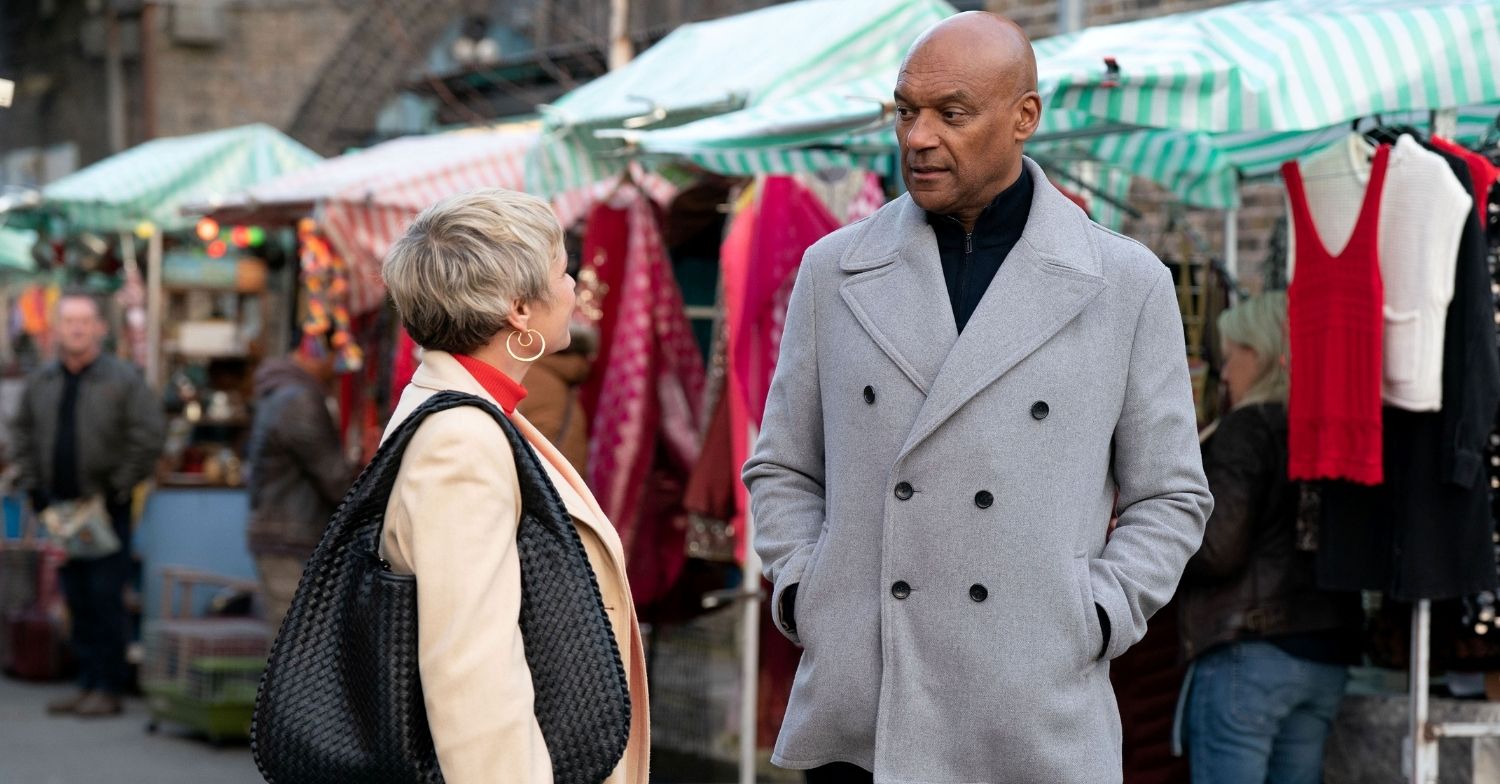 Nicola and George talk in the market in EastEnders 