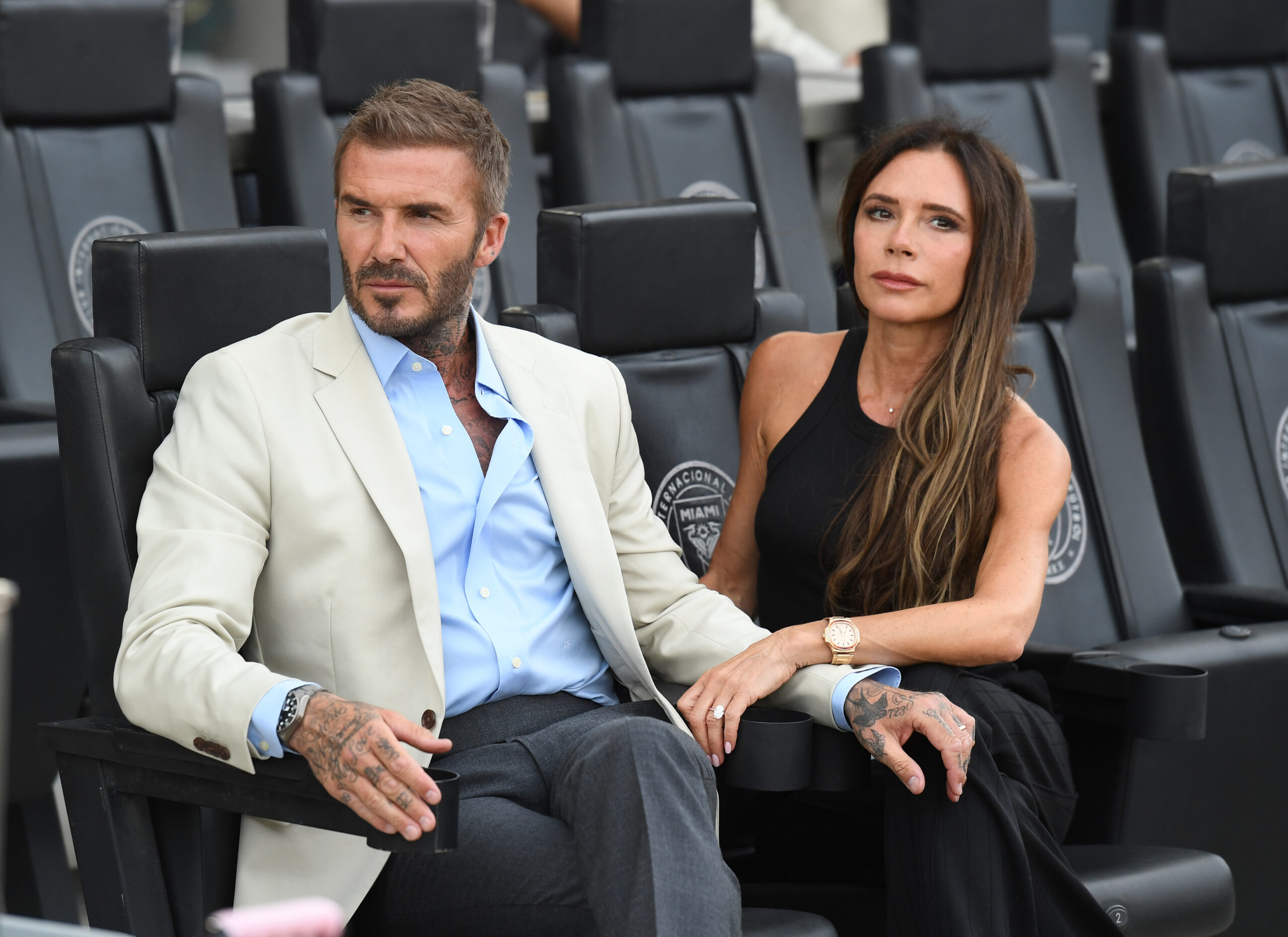 David and Victoria Beckham on seats at event