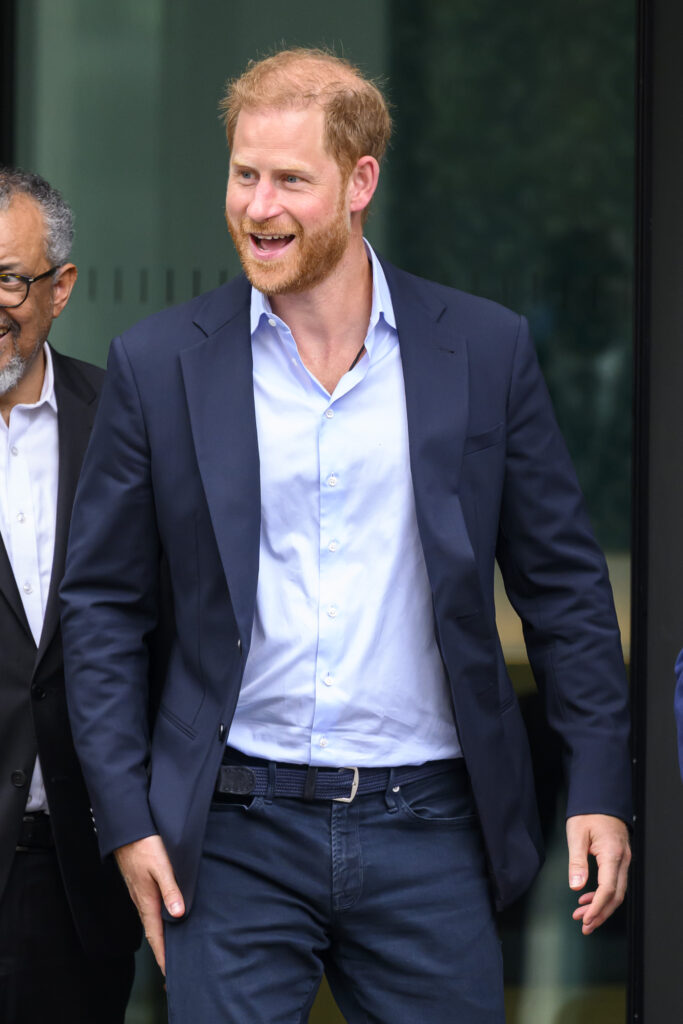 Prince Harry smiling on UK return