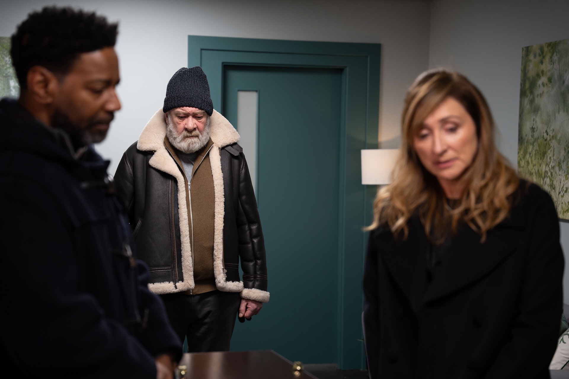 Charles Bear and Laurel look at Ray's coffin