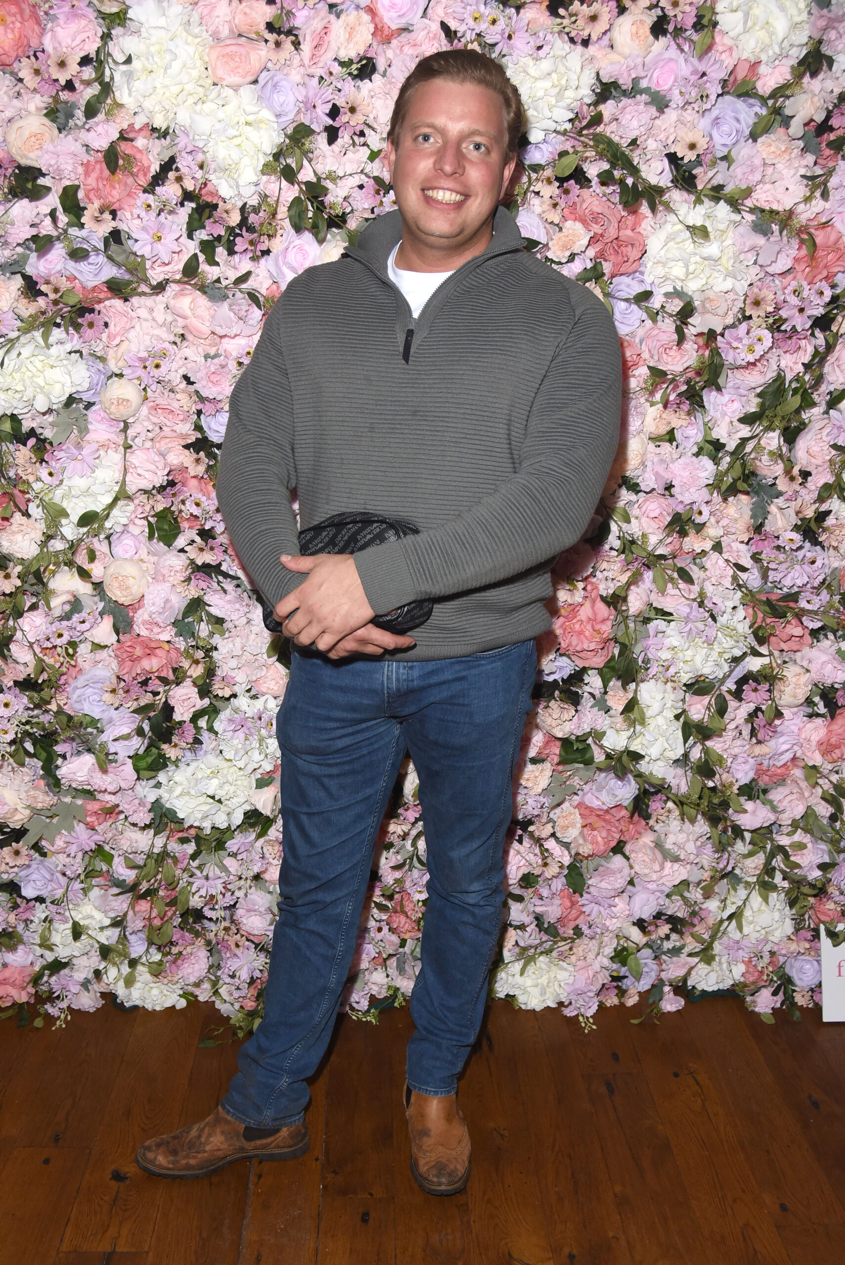Thomas Skinner against a flower wall