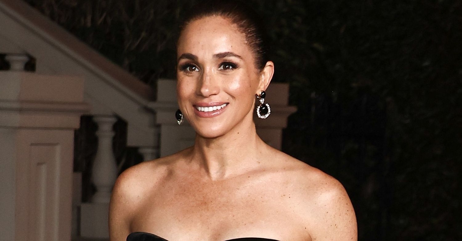 Meghan Markle smiling in strapless dress at gala