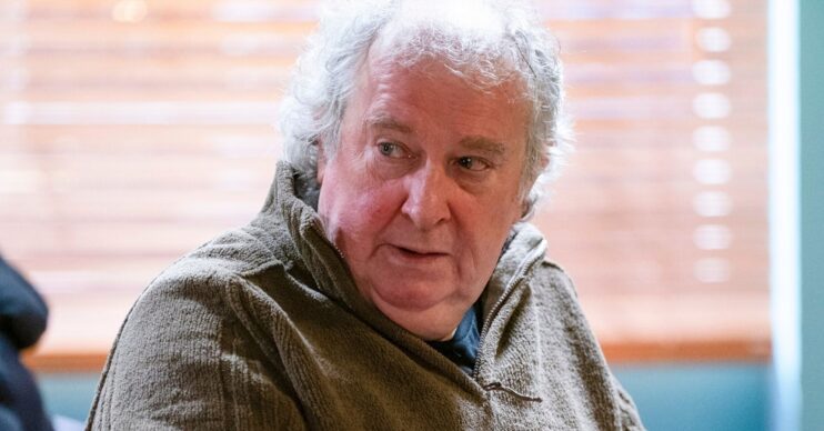 Nigel in EastEnders sitting in the cafe