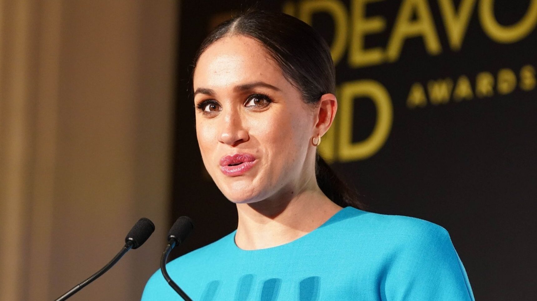 Meghan Markle talking into a microphone