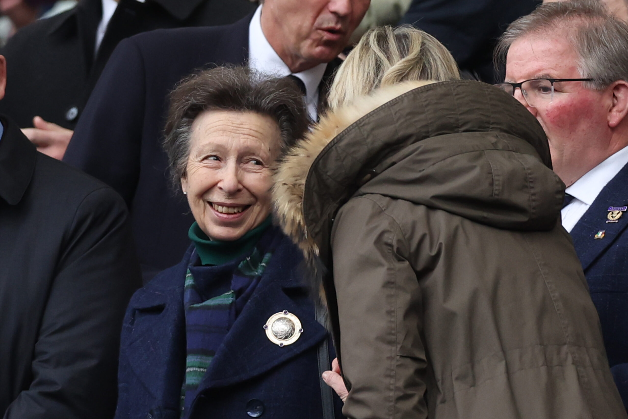 Princess Anne smiling in the crowd at a rugby event