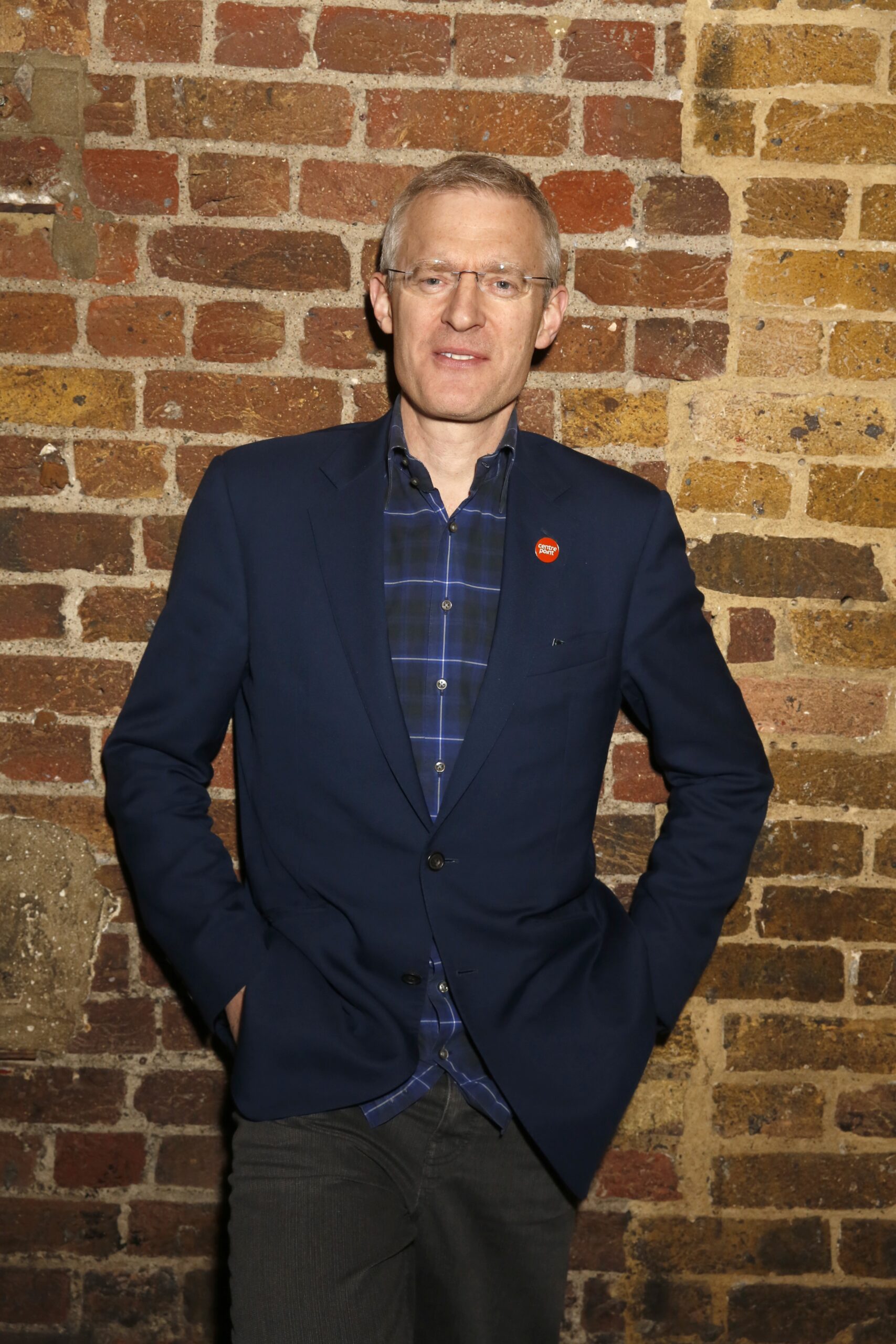 Jeremy Vine standing against a brick wall