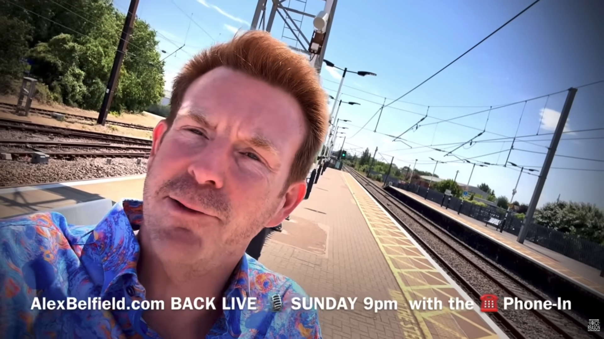 Alex Belfield at a train station