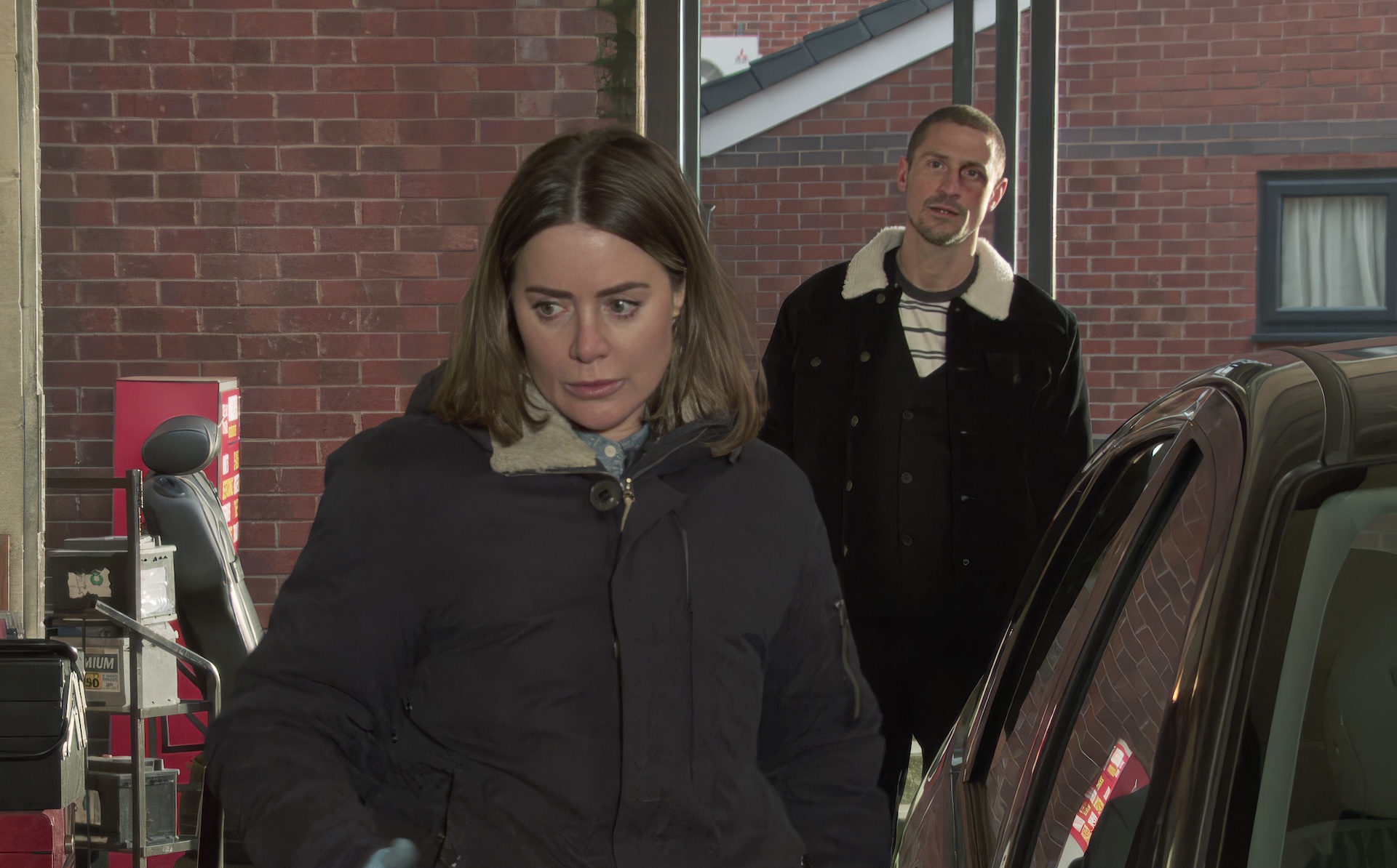 Abi looks nervous as Carl talks to her