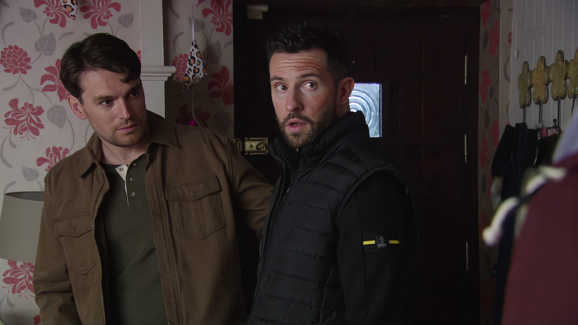 Mack looks confused and Ross looks uncomfortable in Emmerdale