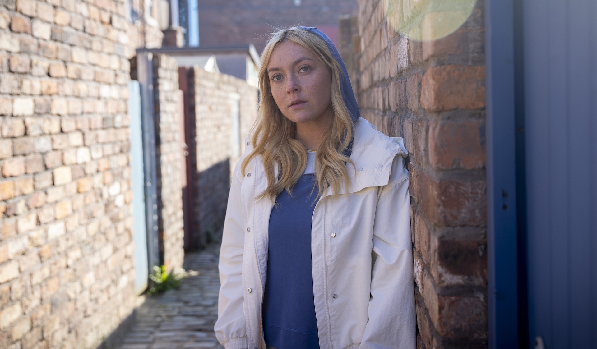 Megan with hood up in the ginnel