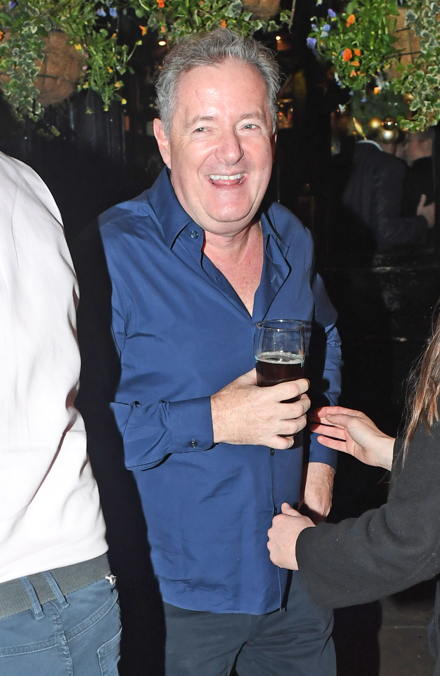 Piers Morgan holding a beer