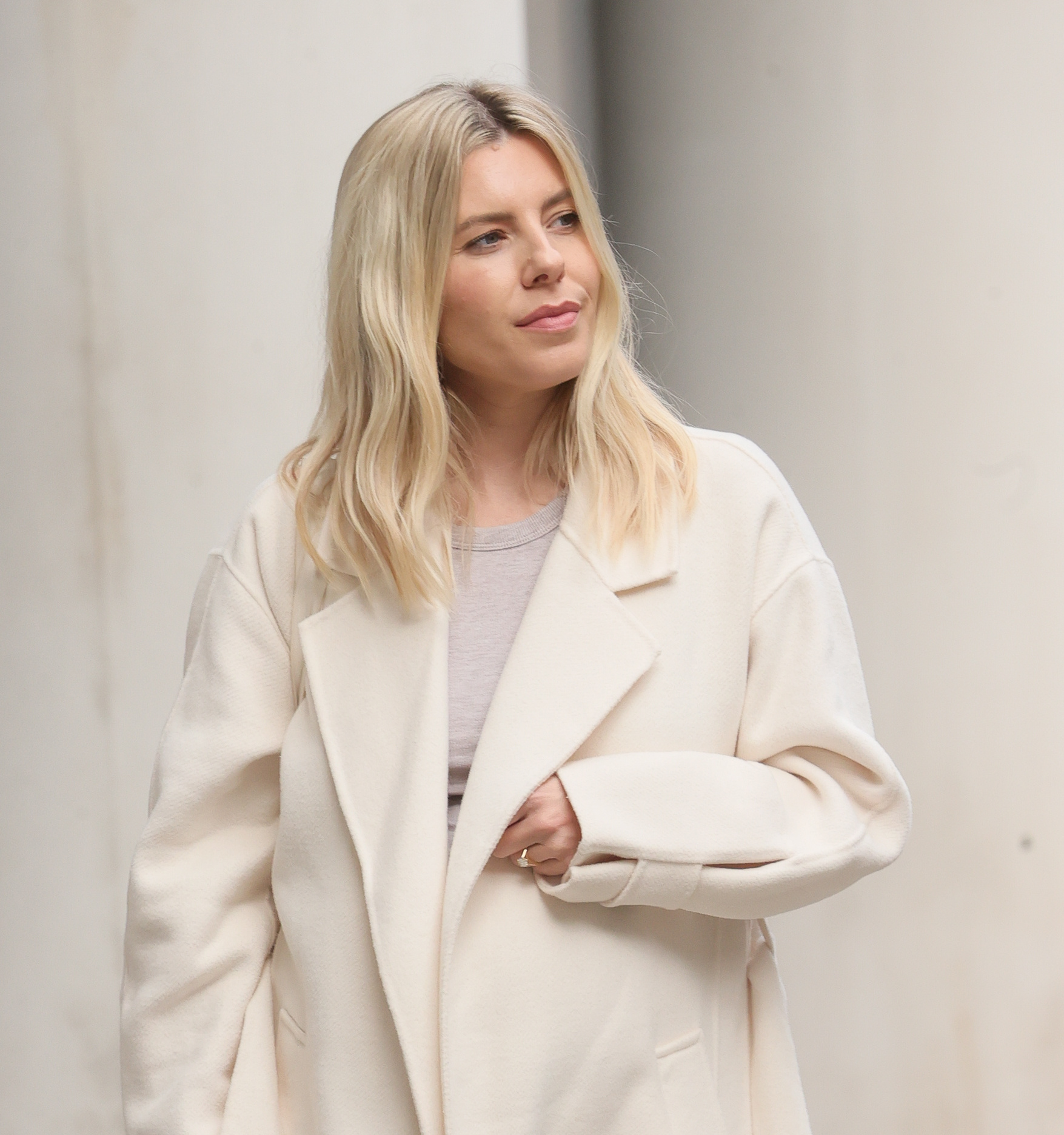 Mollie King looking to the side