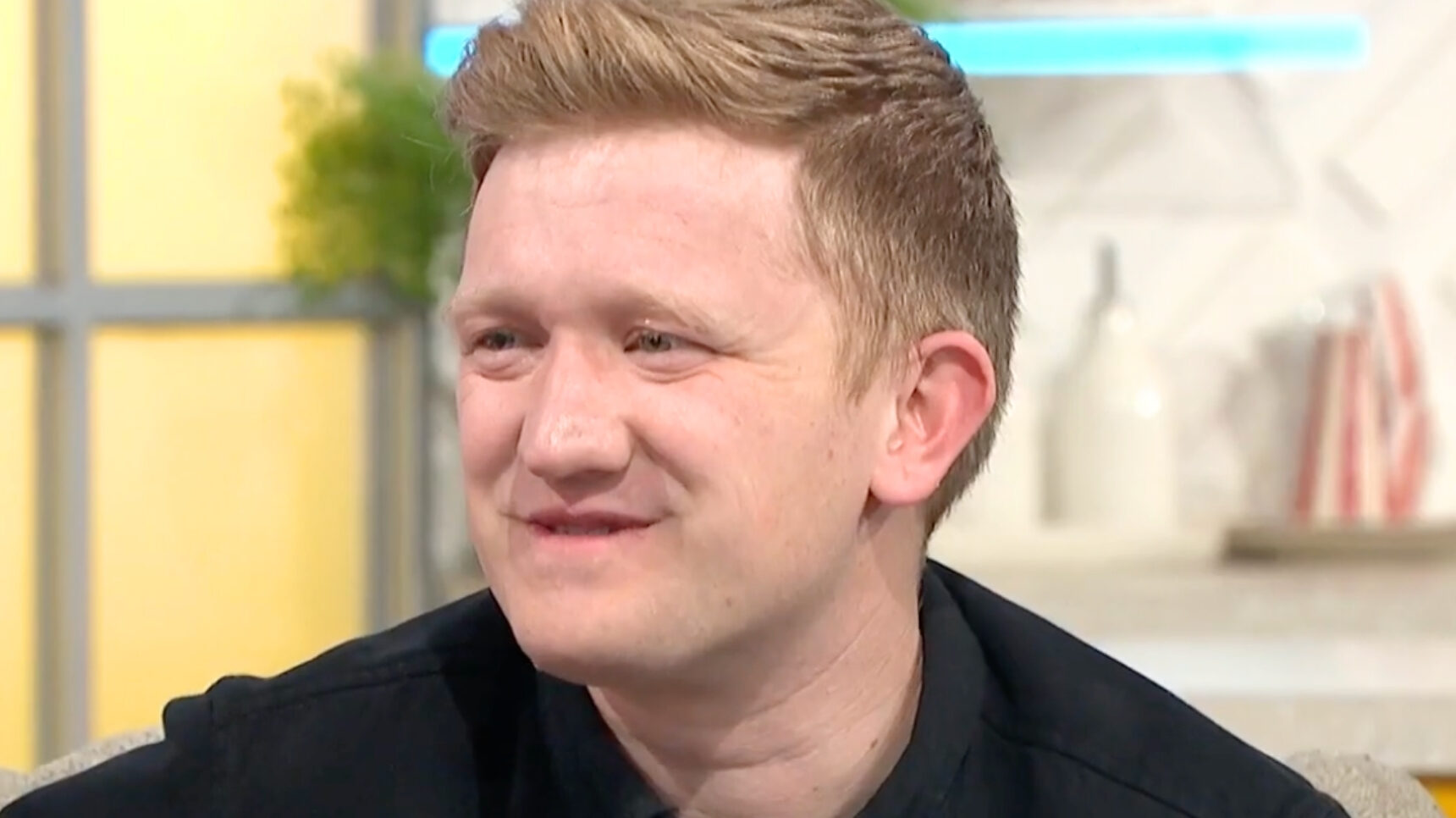 Coronation Street's Sam Aston smiling