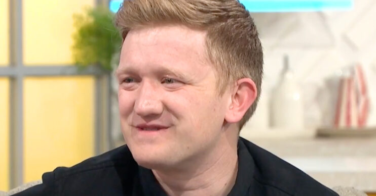 Coronation Street's Sam Aston smiling
