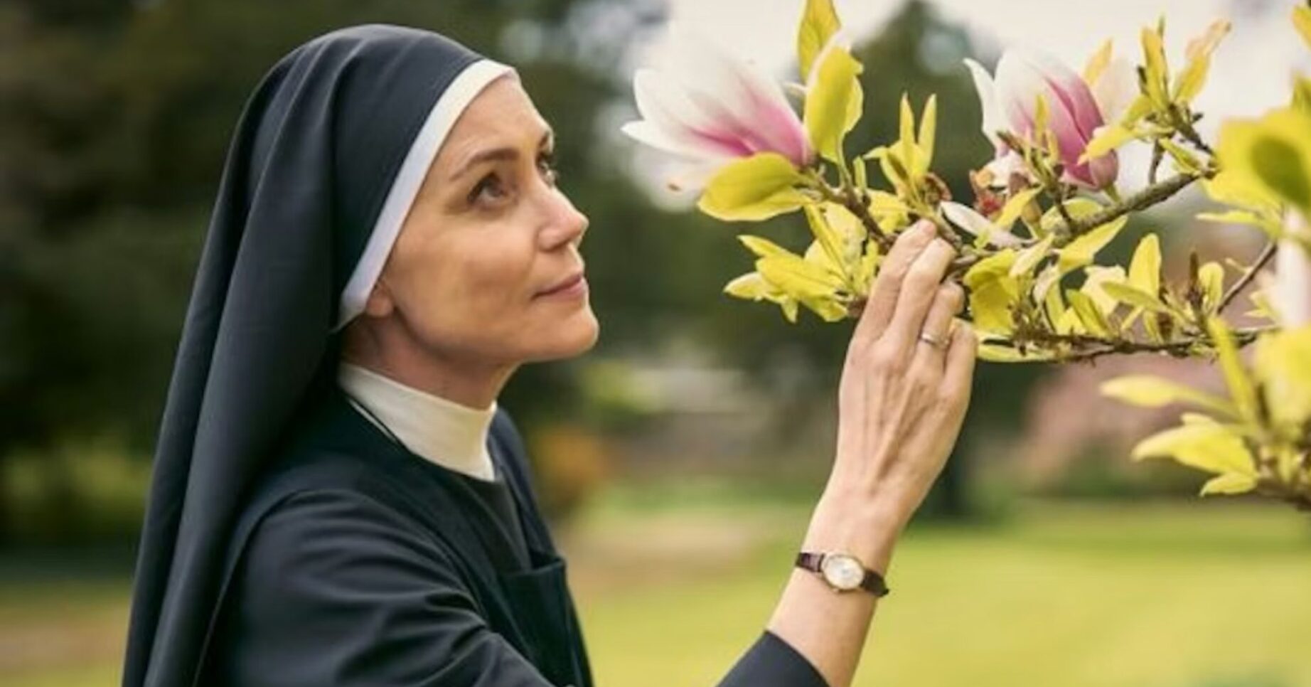 Keeley Hawes looking at a flower in Falling