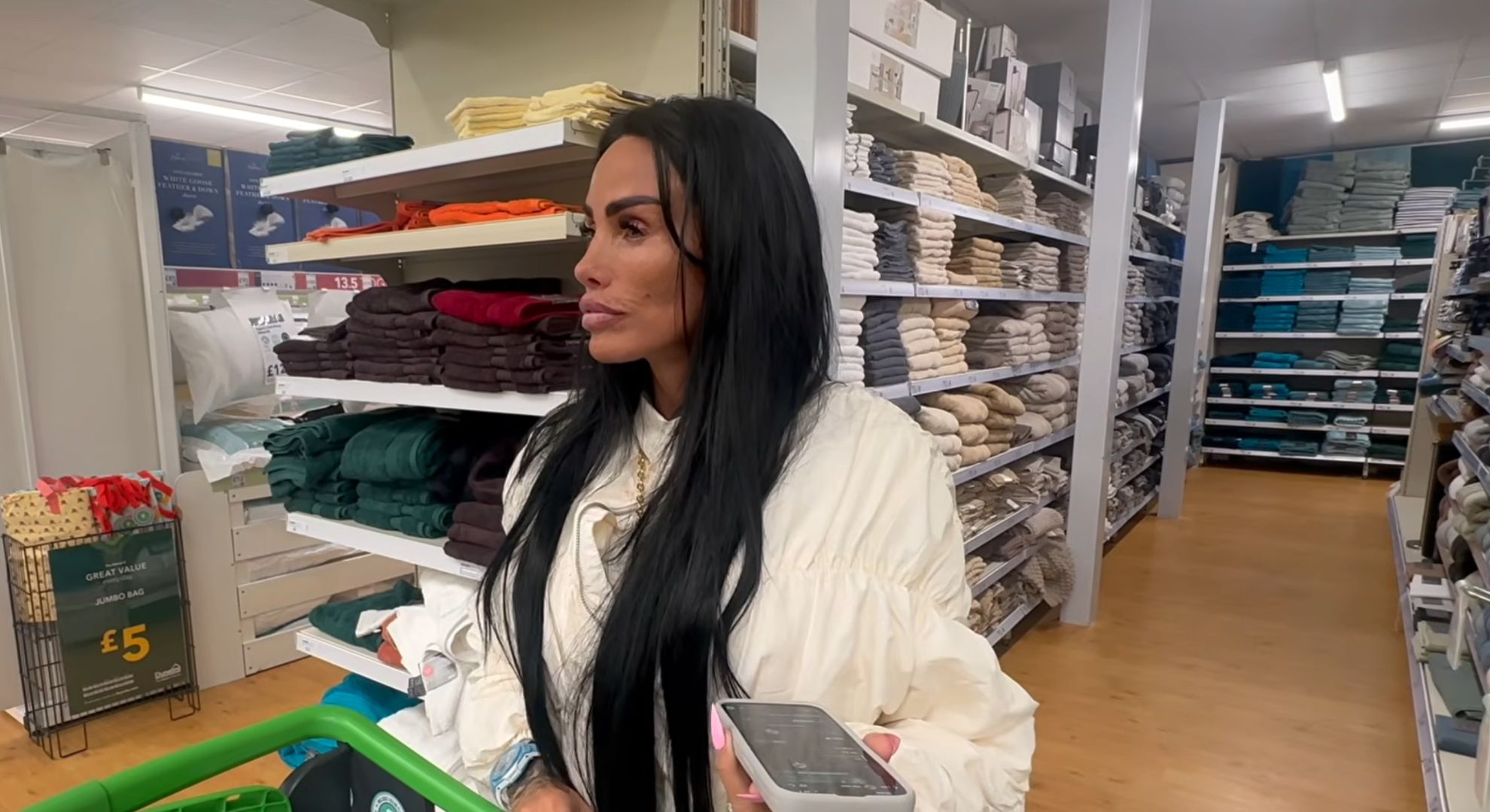 Katie Price listening to a voice note