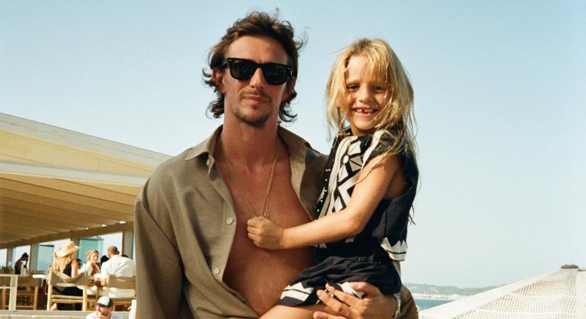 Jake Hall carrying daughter