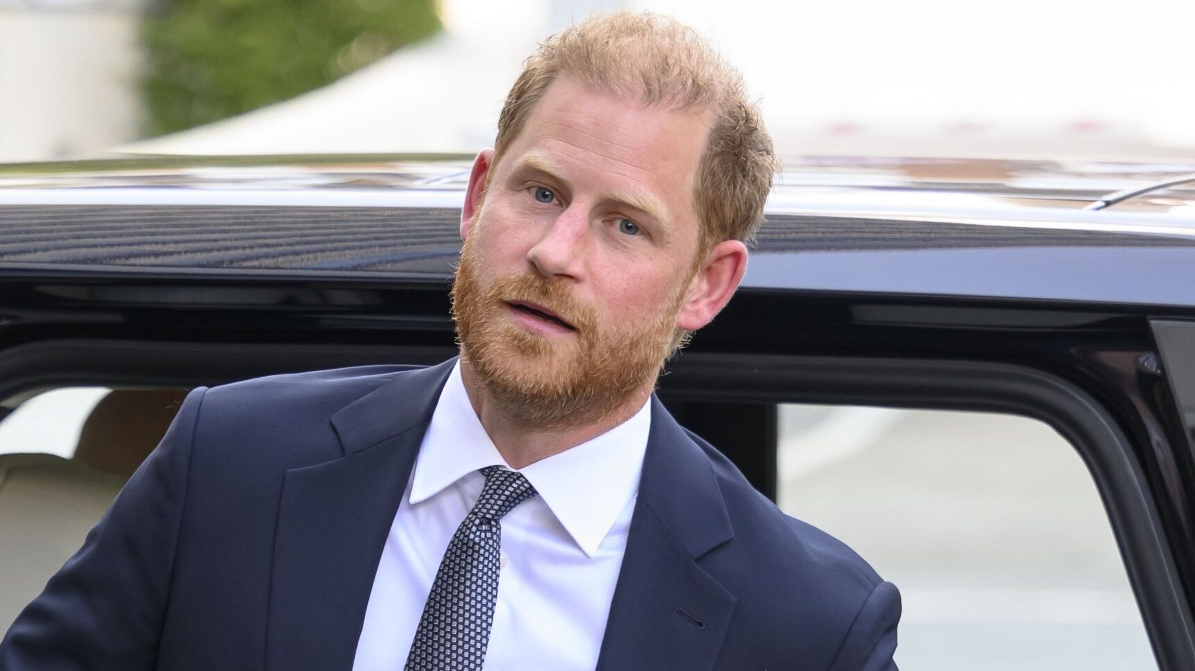 Prince Harry getting out of car in suit