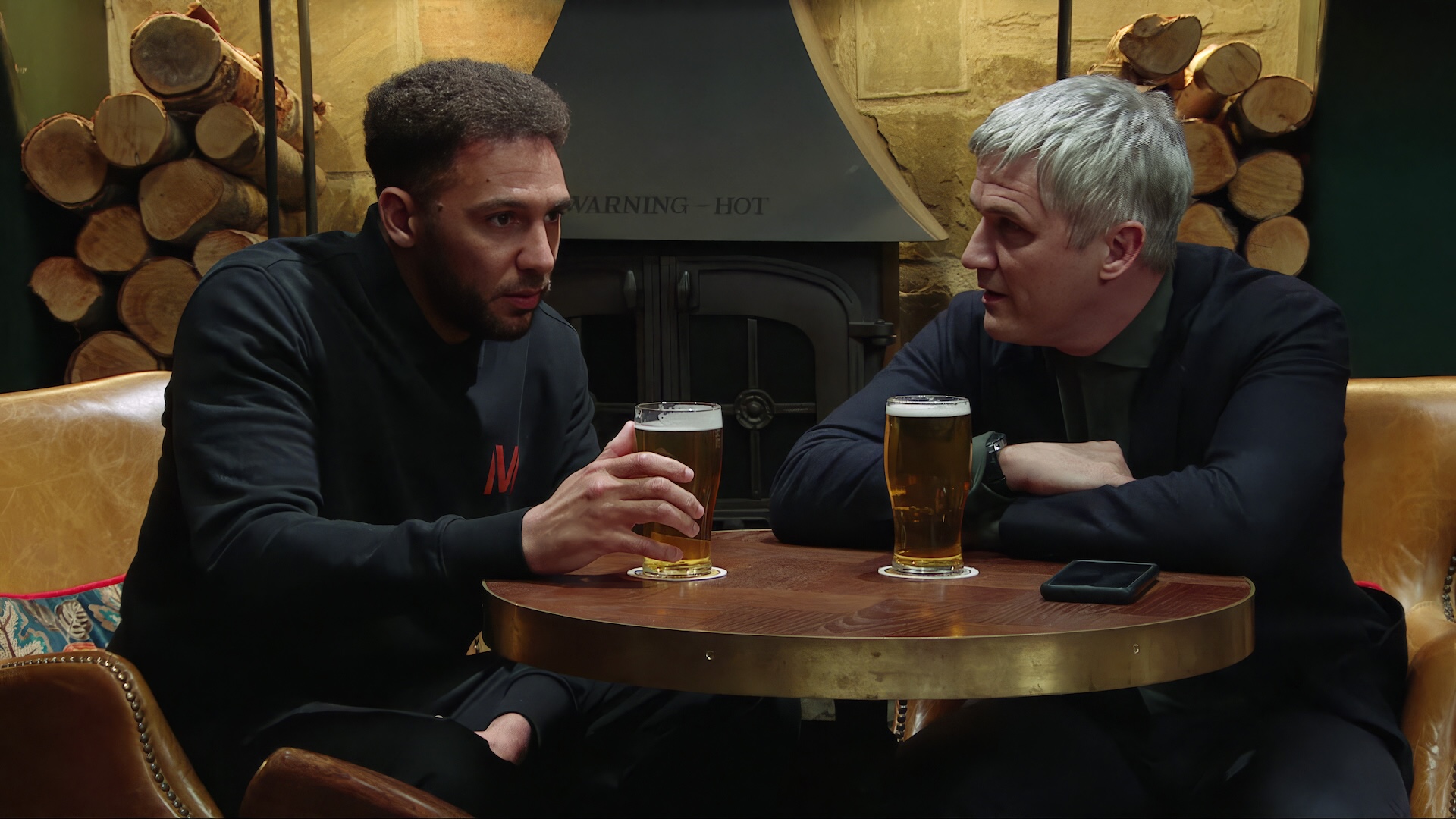 Billy looks unsure as Caleb makes him an offer over a pint