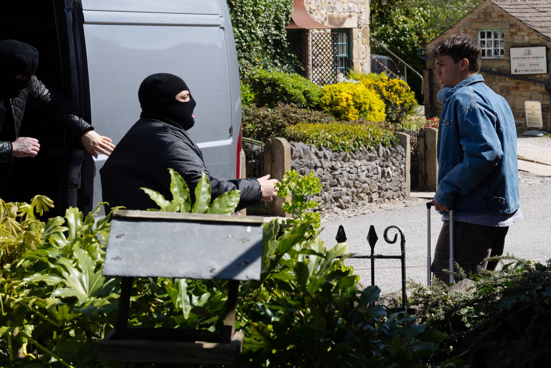 Lewis is confronted by masked men in Emmerdale (Credit: ITV)
