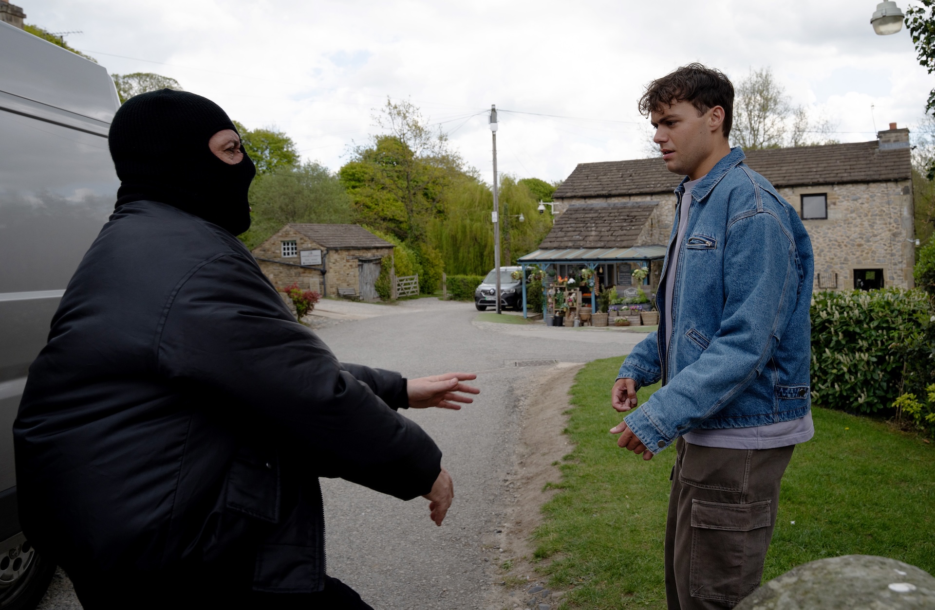 A man in a balaclava grabs Lewis