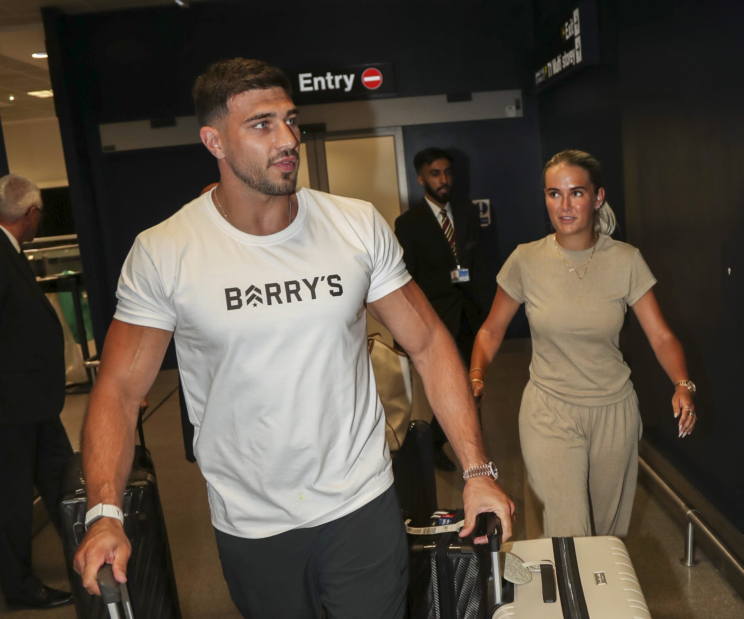 Tommy Fury and Molly-Mae walking through an airport