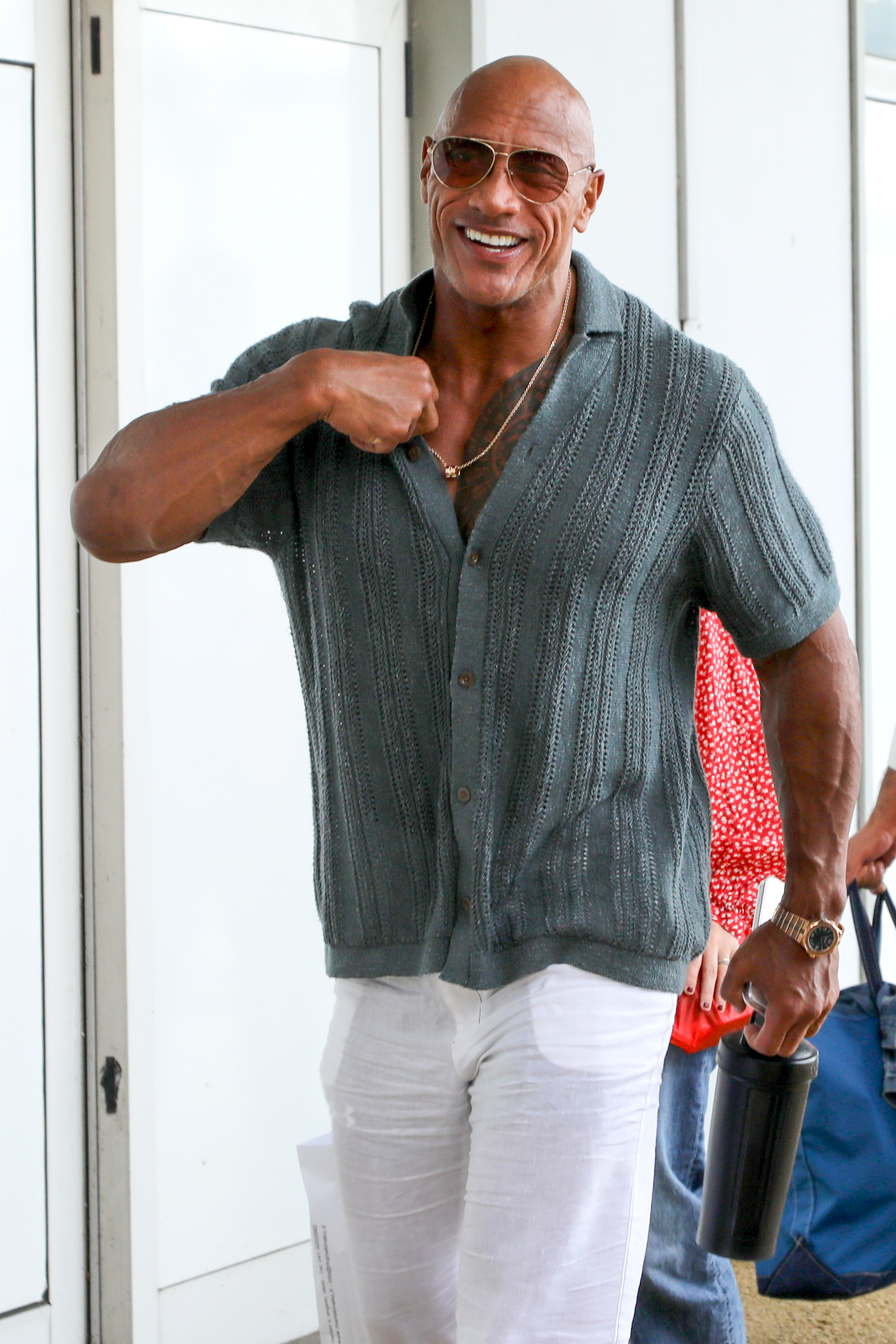 Dwayne Johnson smiling touching his collar