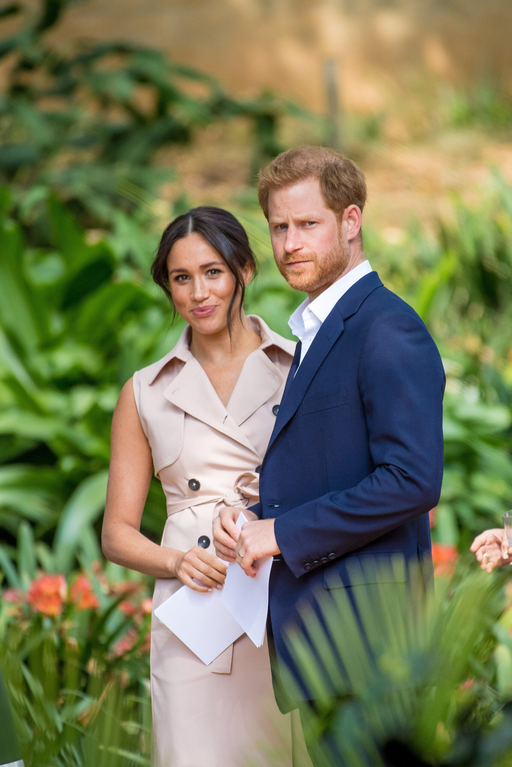 Meghan Markle and Prince Harry looking at camera