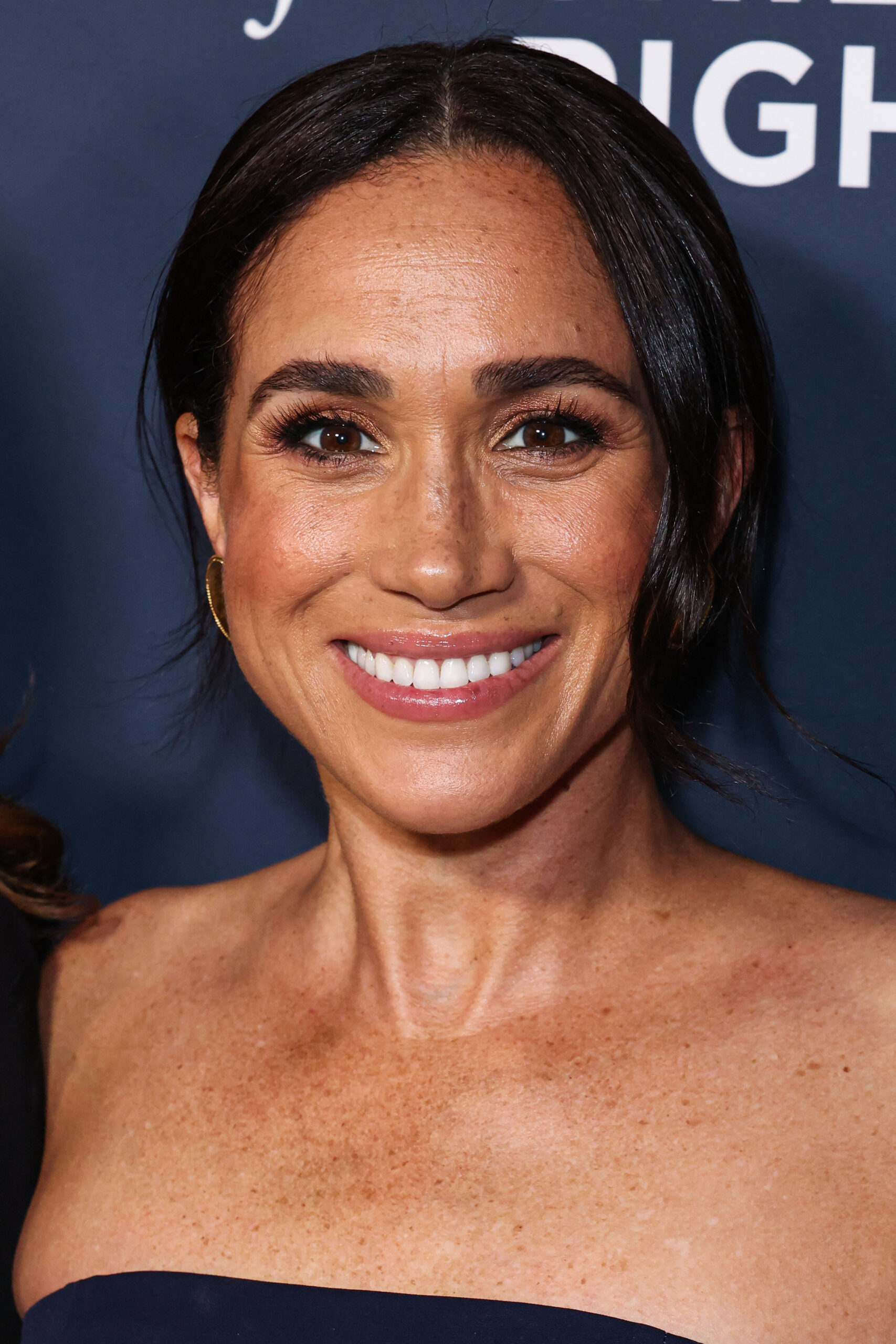 Meghan Markle beaming a happy smile