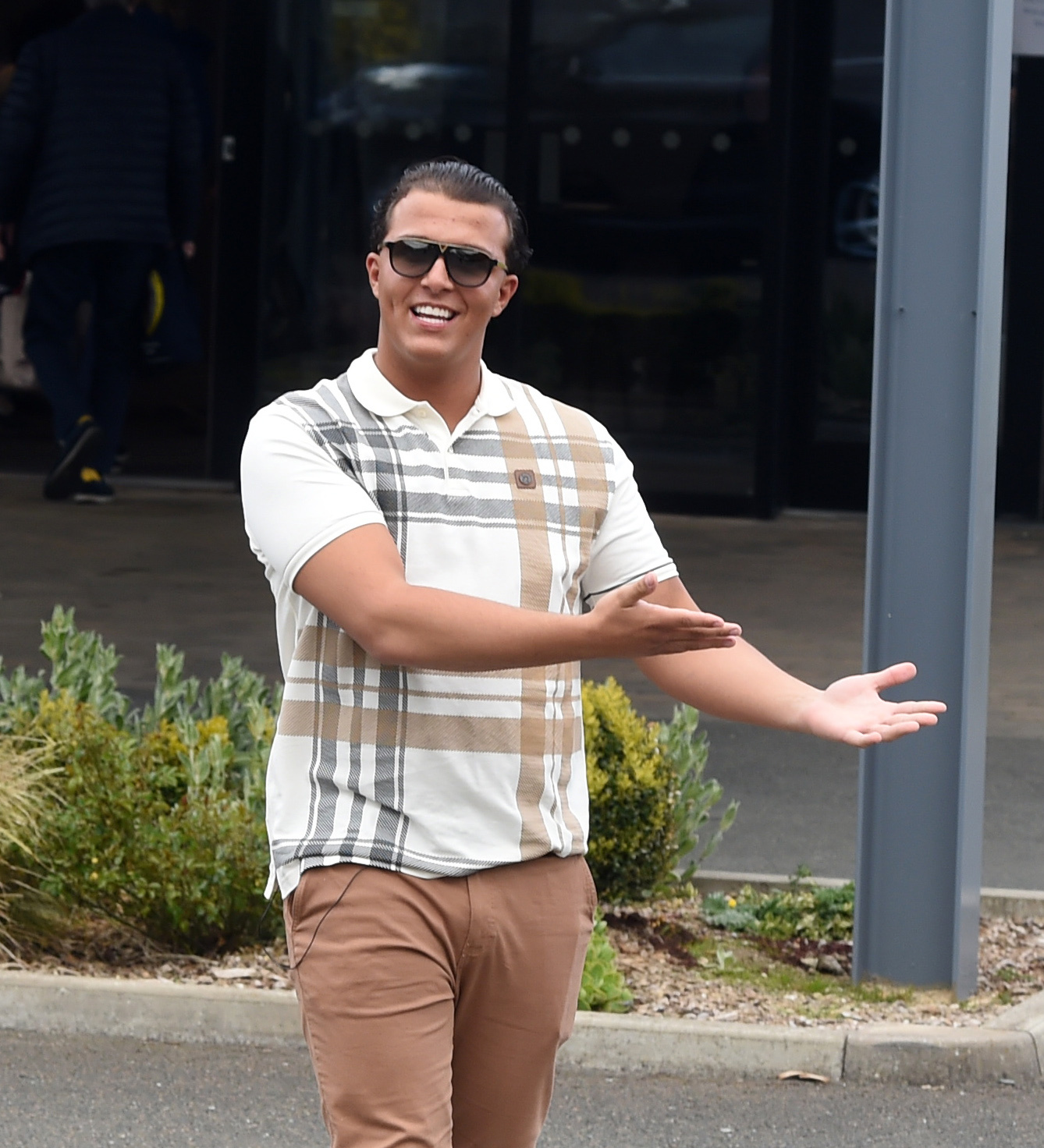 Noah Price smiling with his arms stretched outwards