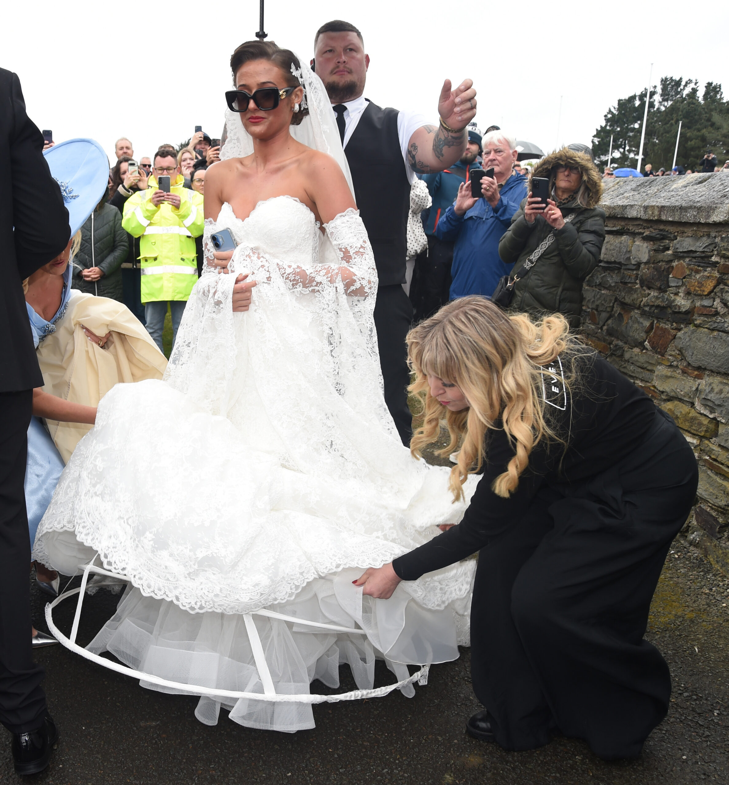 Venezuela Fury wearing sunglasses and a white lace gown on her wedding day