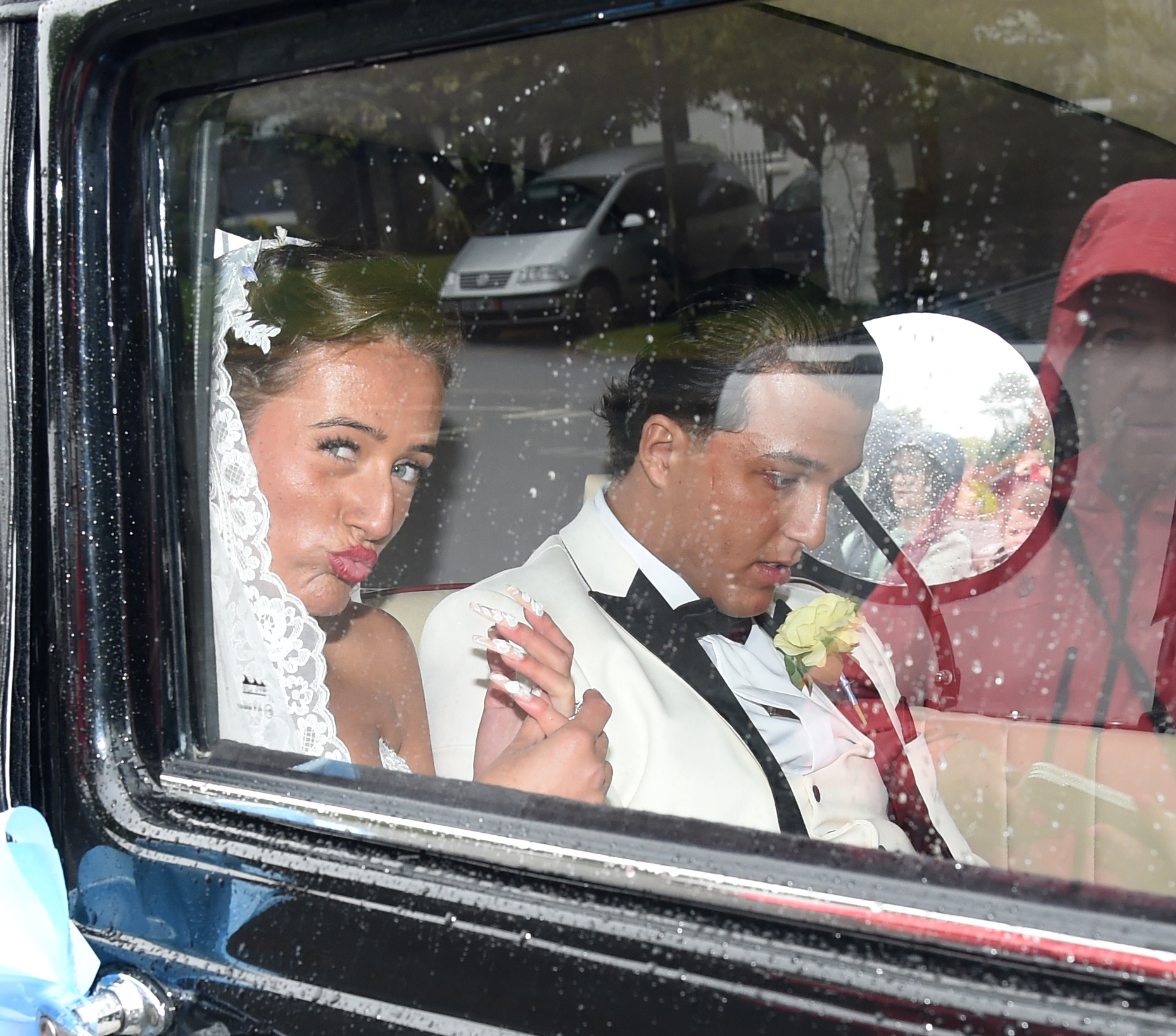 Venezuela Fury pouting as she looks out of the car window besie Noah Price on her wedding day