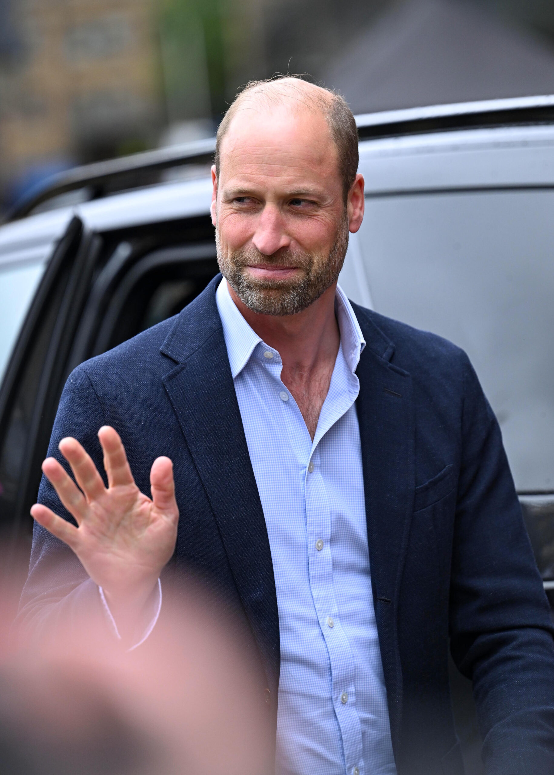 Prince William waving and smiling during royal engagement