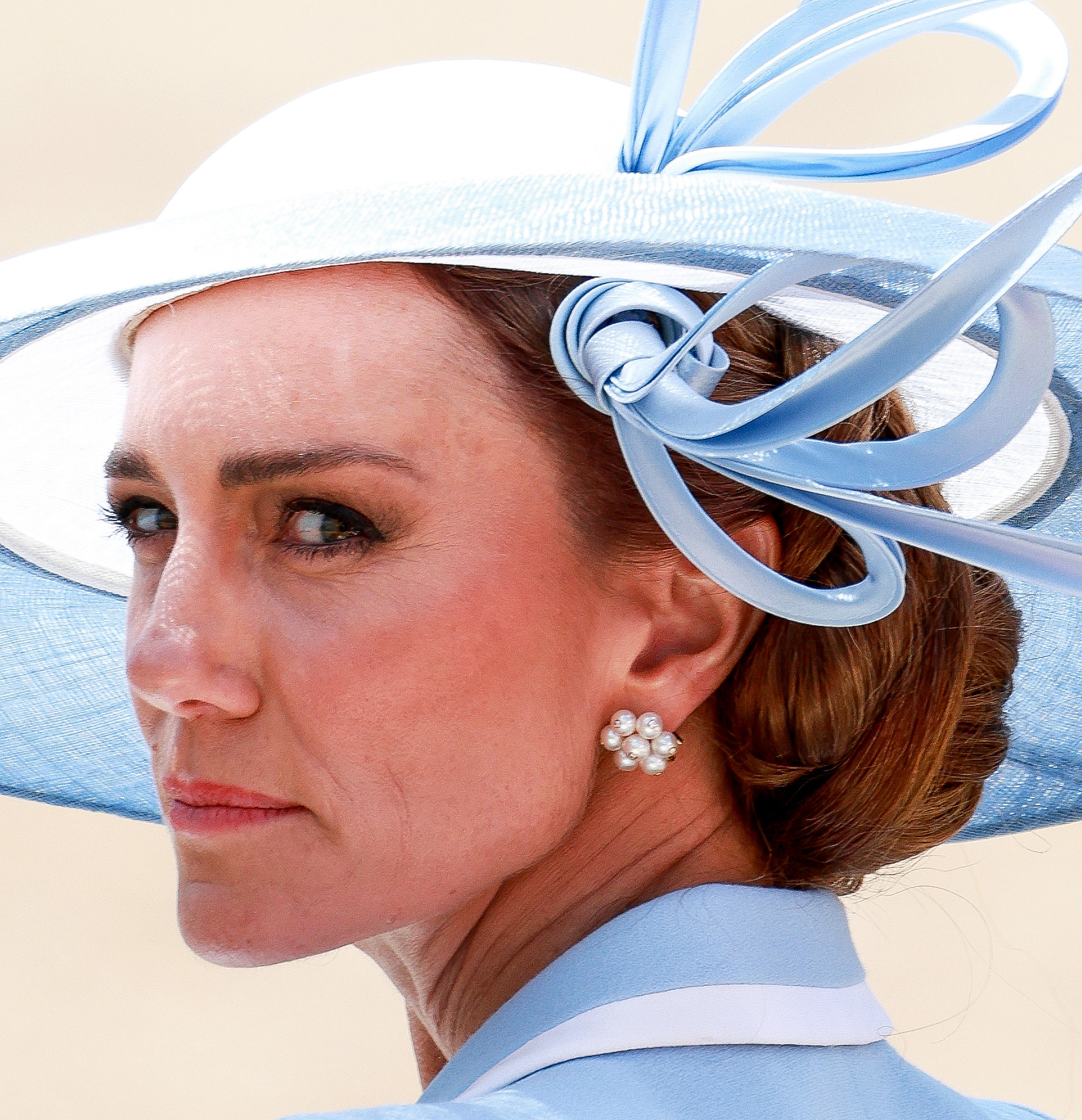 Princess Kate Middleton frowning wearing a blue hat at Trooping the Colour
