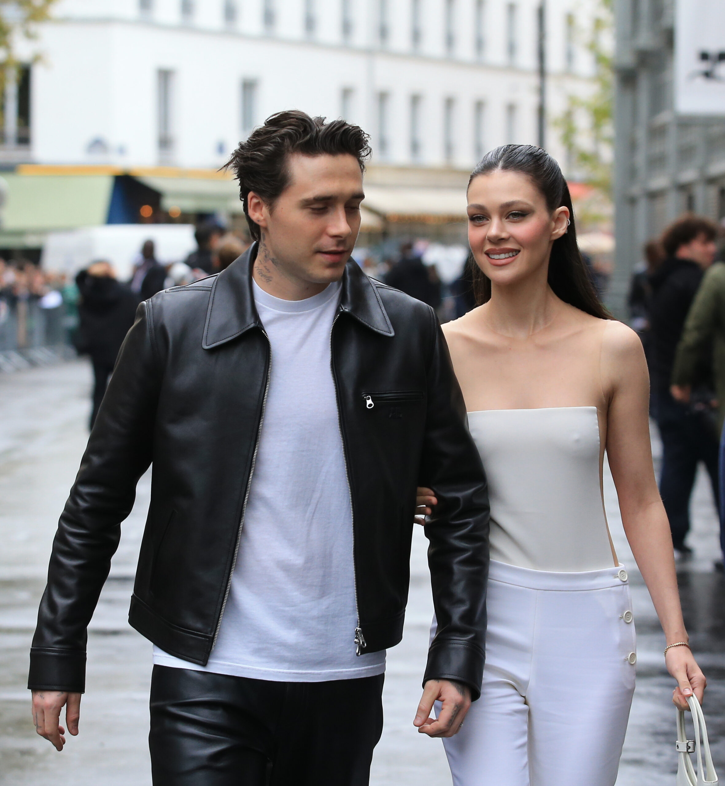 Brooklyn Beckham and Nicola Peltz smiling as they walk together