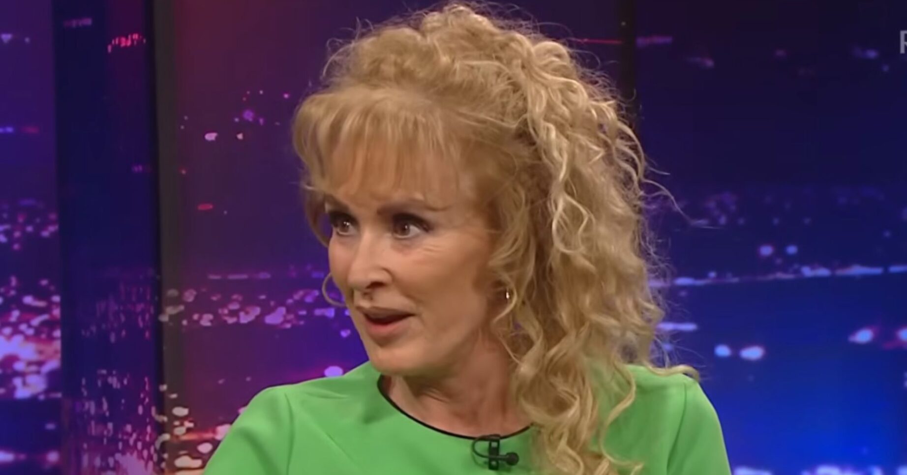 Beverley Callard in green dress on TV show
