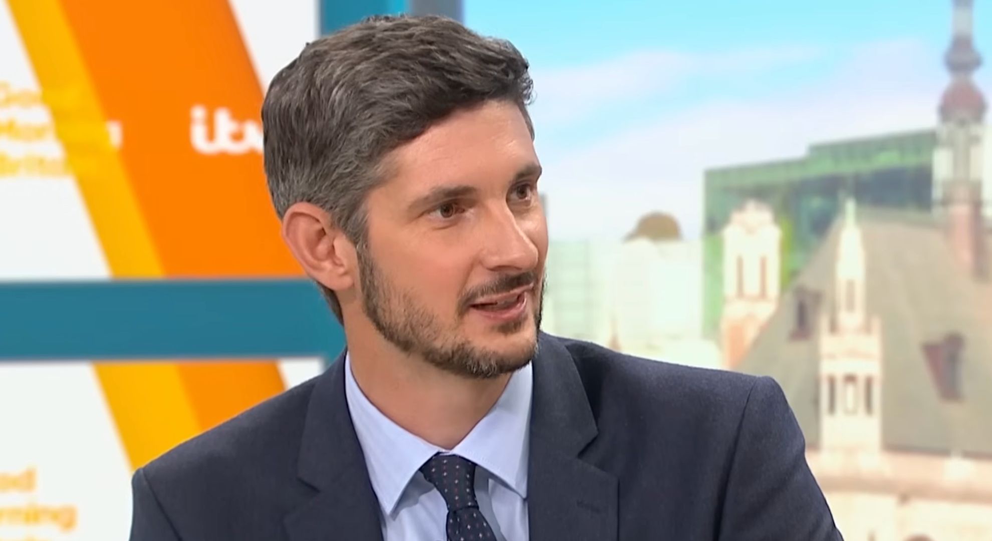 Tom Swarbrick on Good Morning Britain, looking away from the camera and smiling
