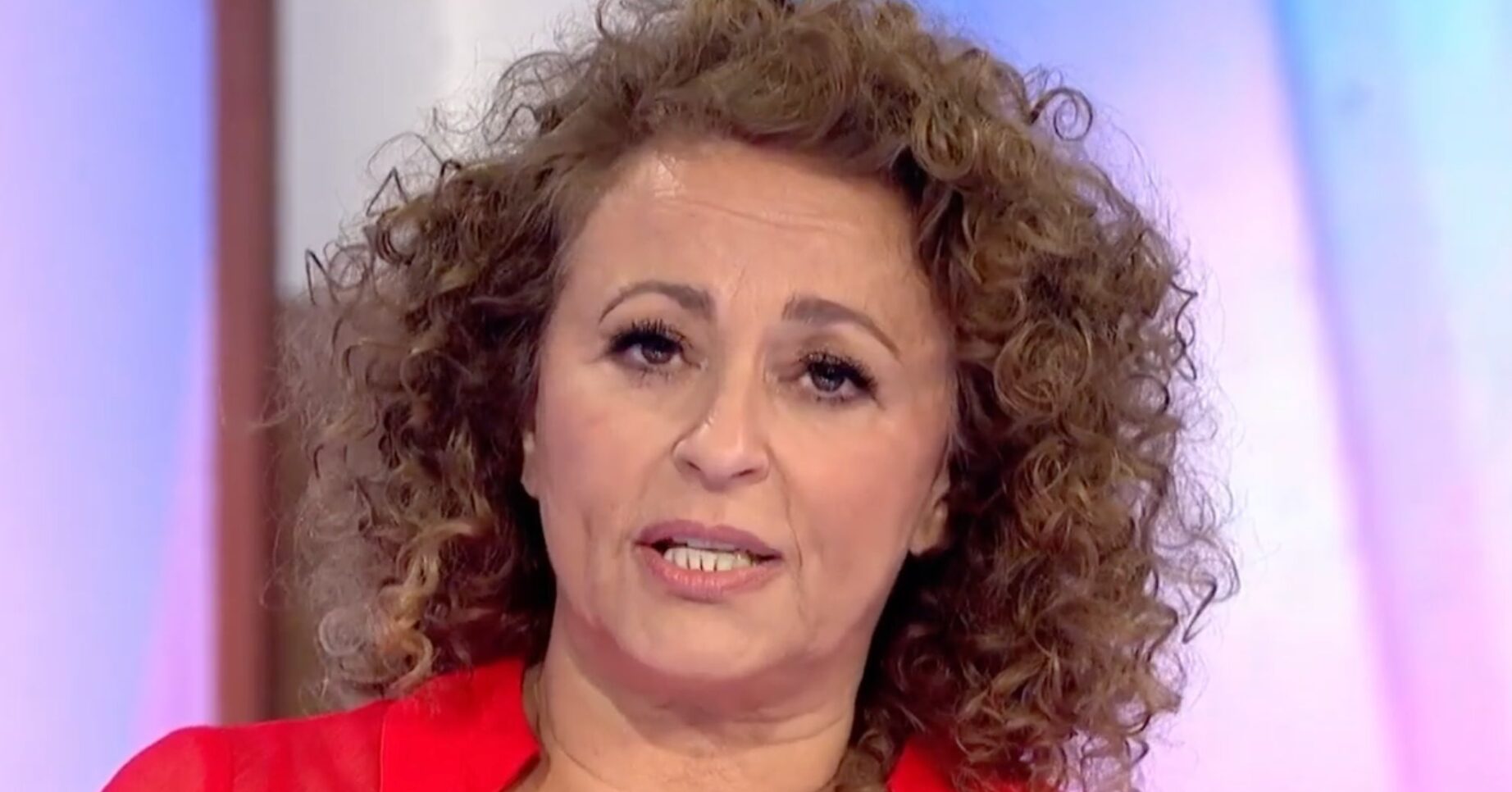 Nadia Sawalha on Loose Women, frowning, wearing red