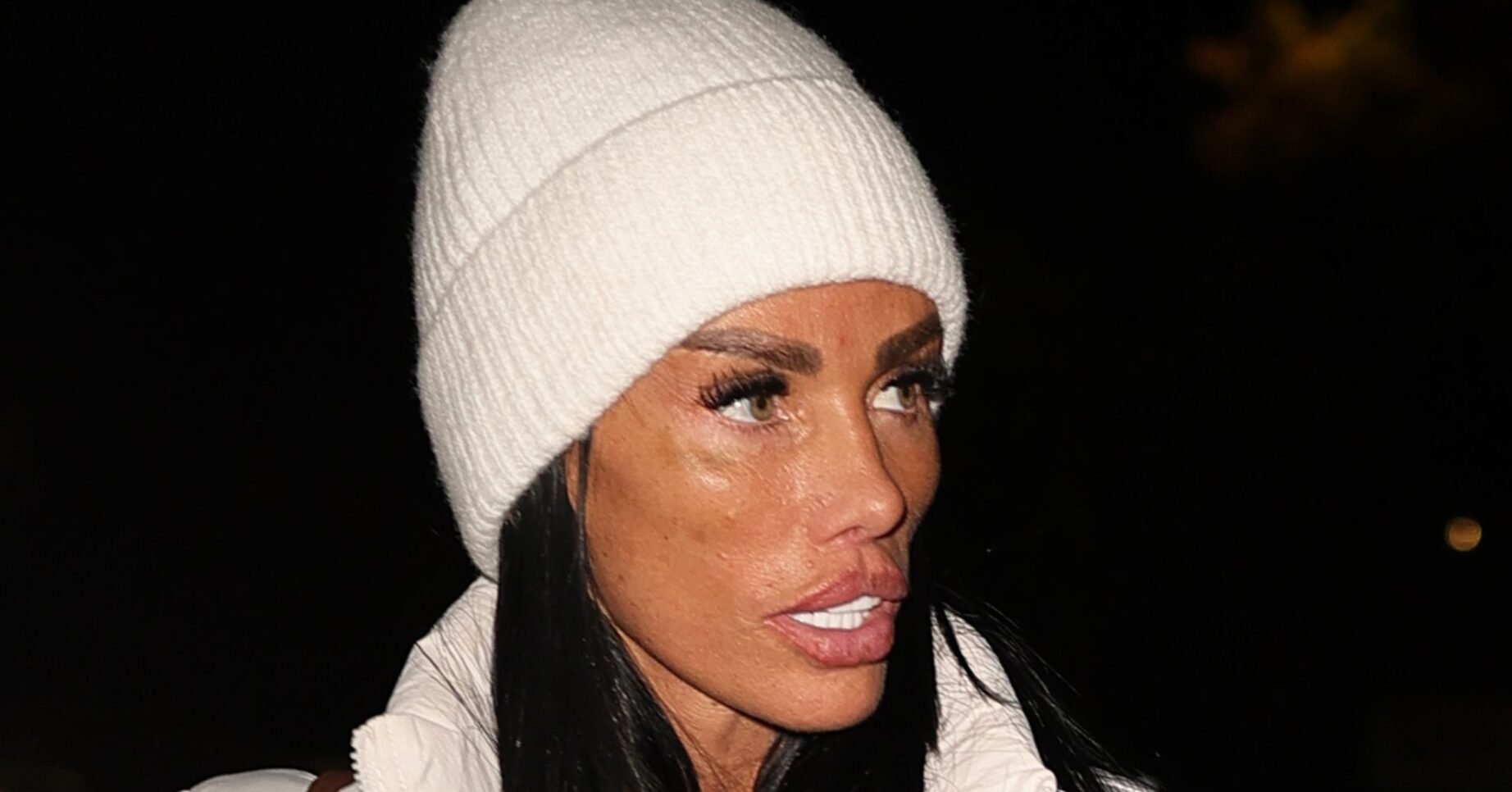 Katie Price wearing a white hat with a shocked expression