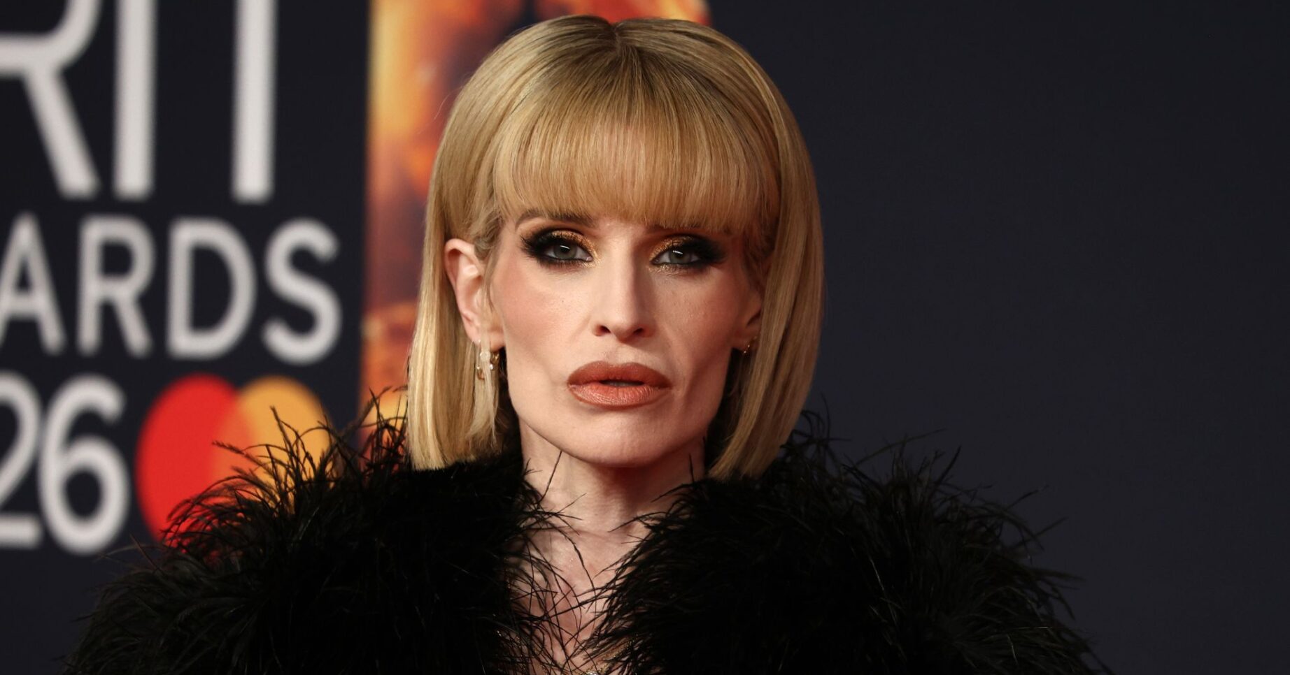 Kelly Osbourne with a serious expression