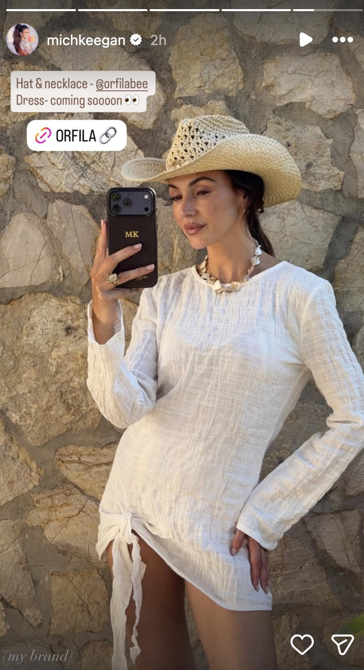 Michelle keegan posing for a selfie in a white cover up 