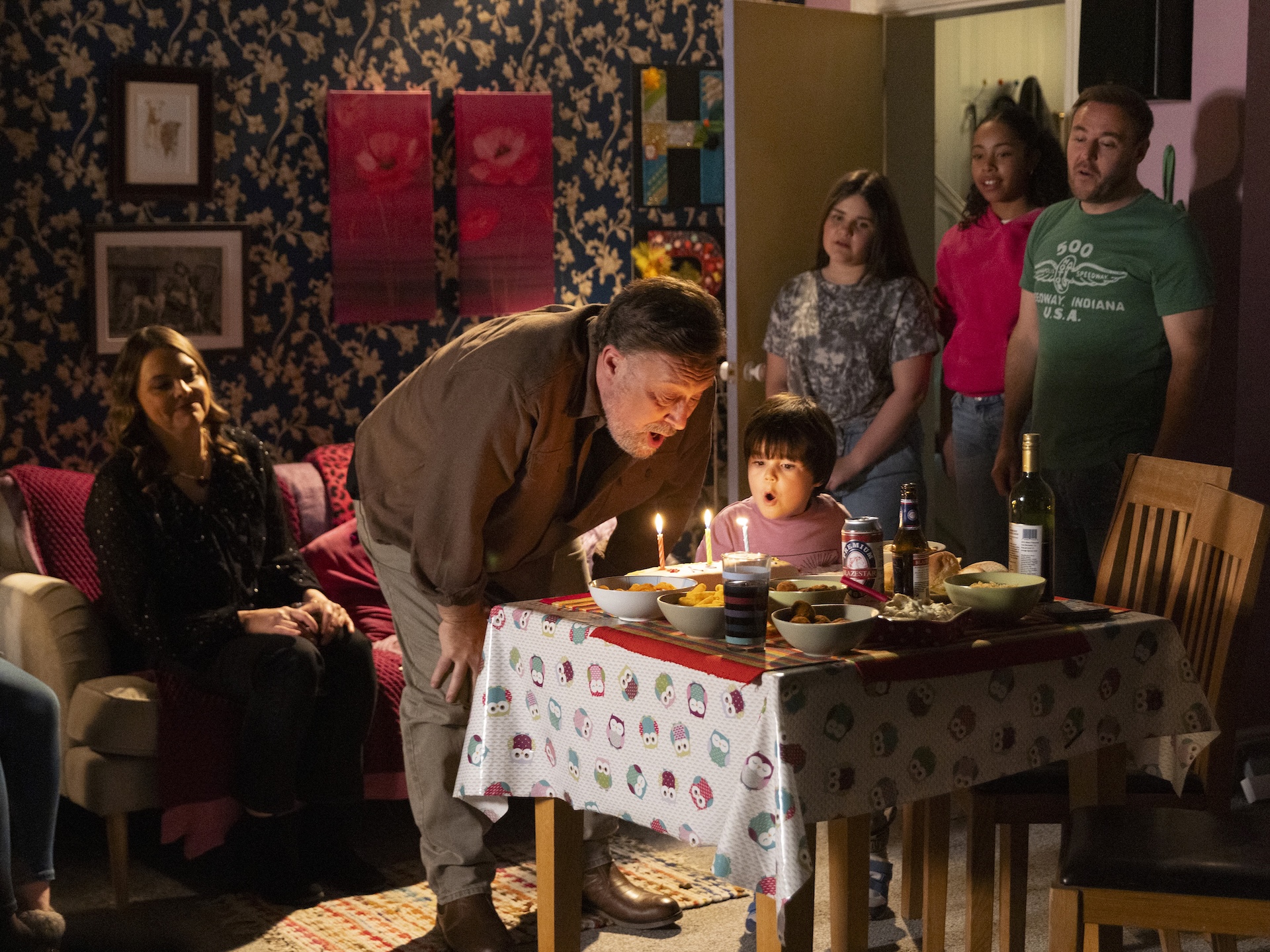 Ross blowing out birthday candles in Coronation Street