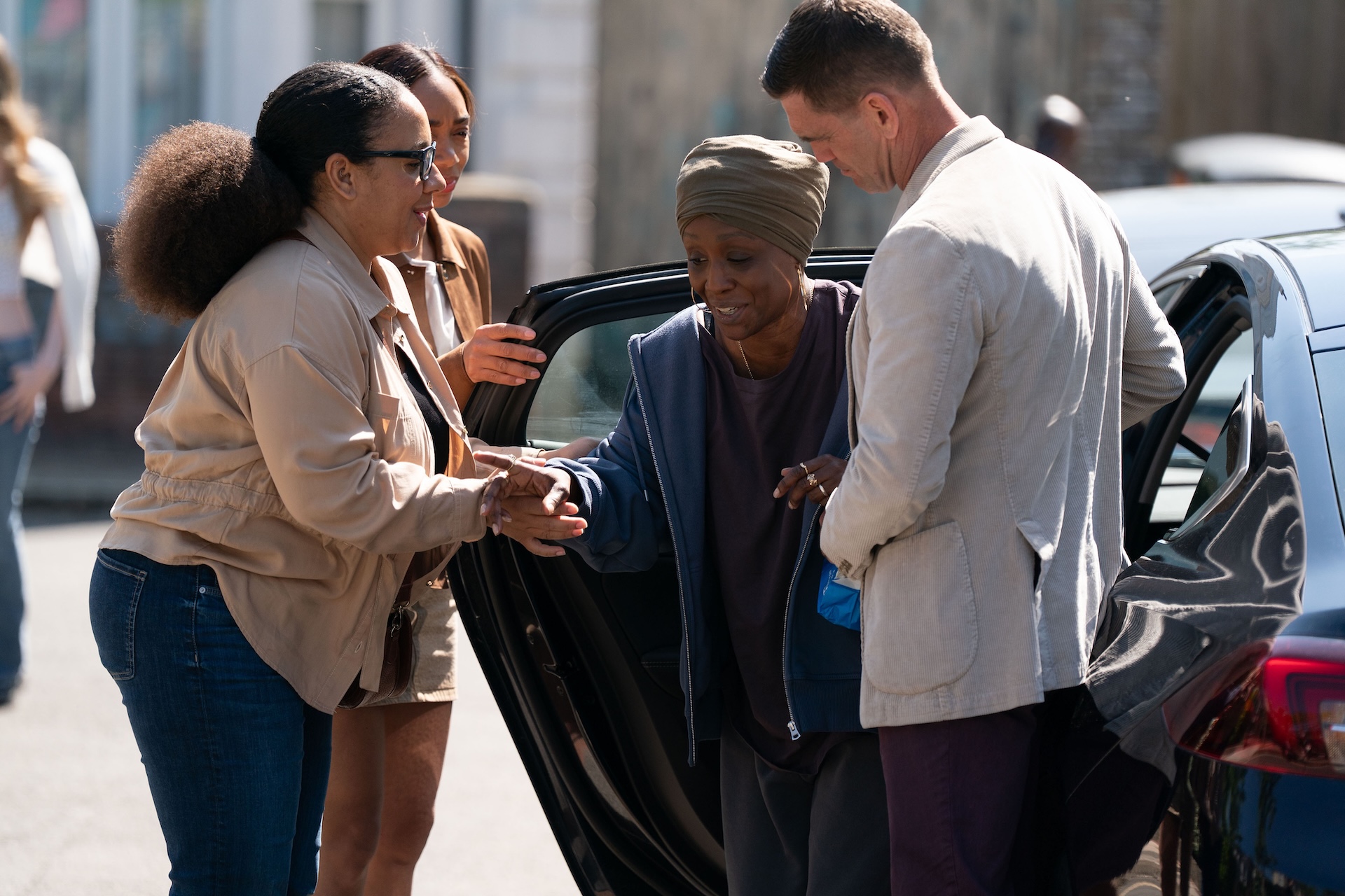 Denise being helped out of the car in EastEnders