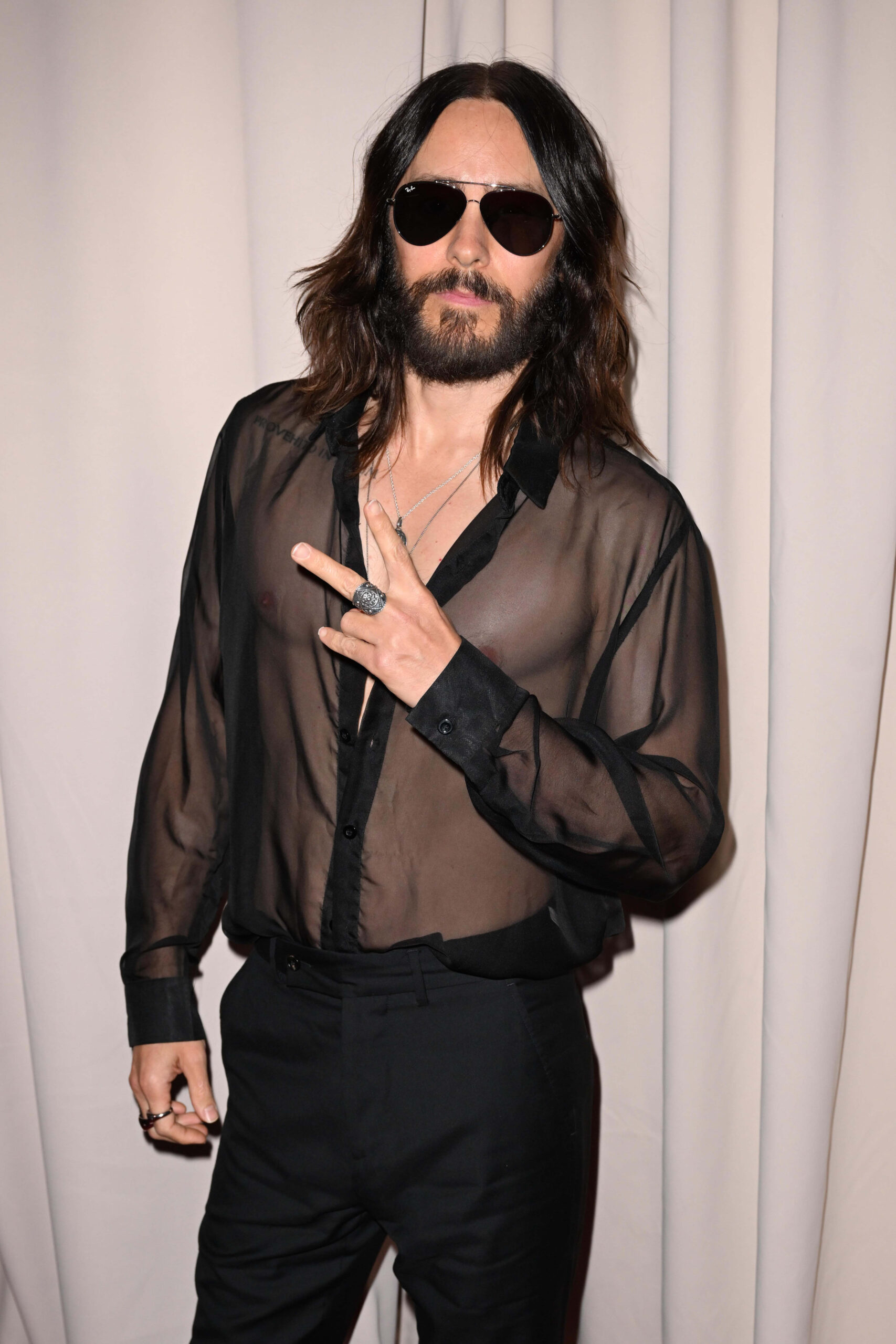 Jared Leto throwing up a peace sign