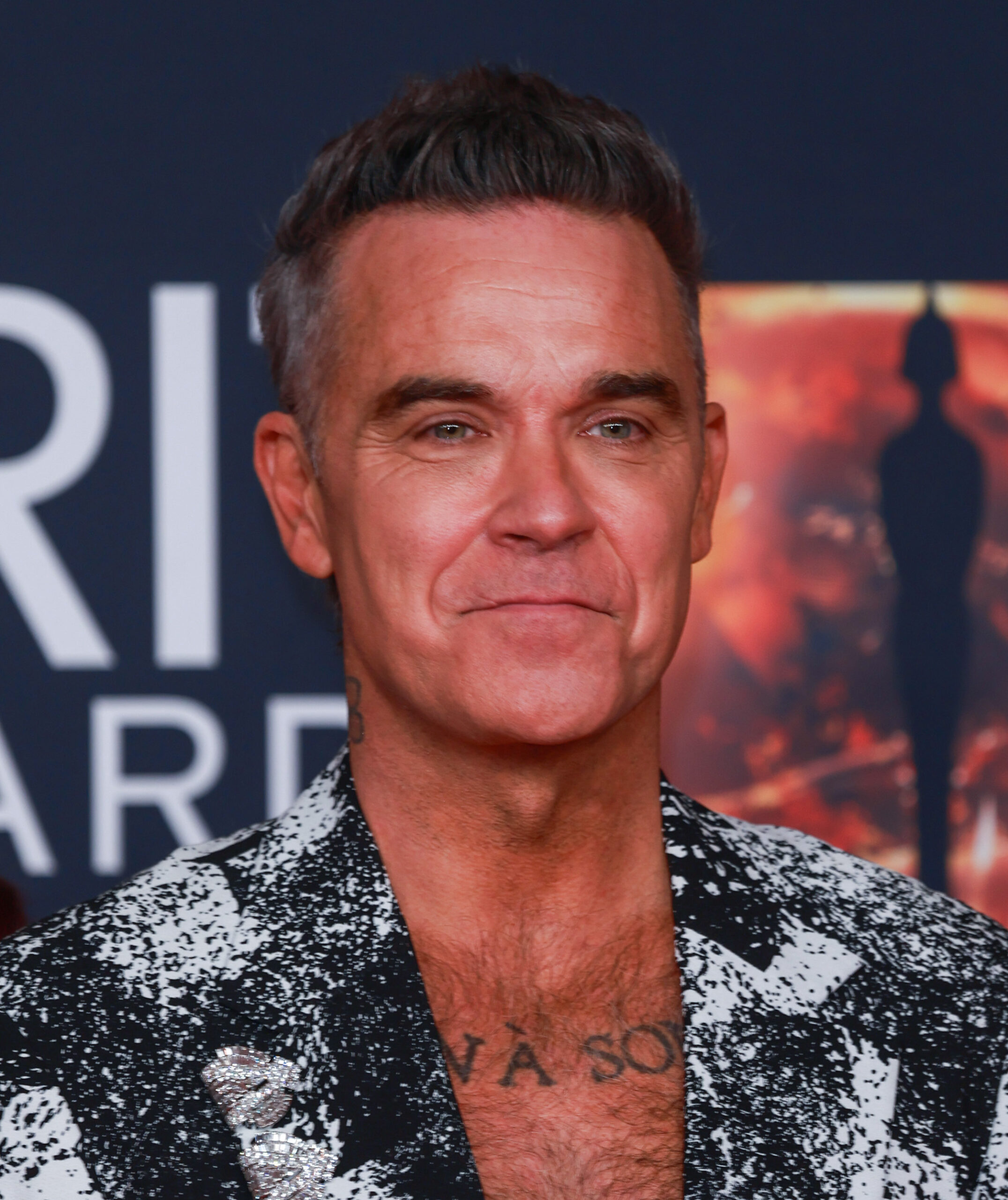 Robbie Williams with a small smile on his face