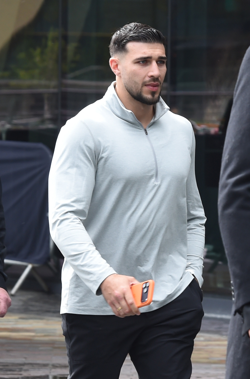 Tommy Fury frowning as he walks