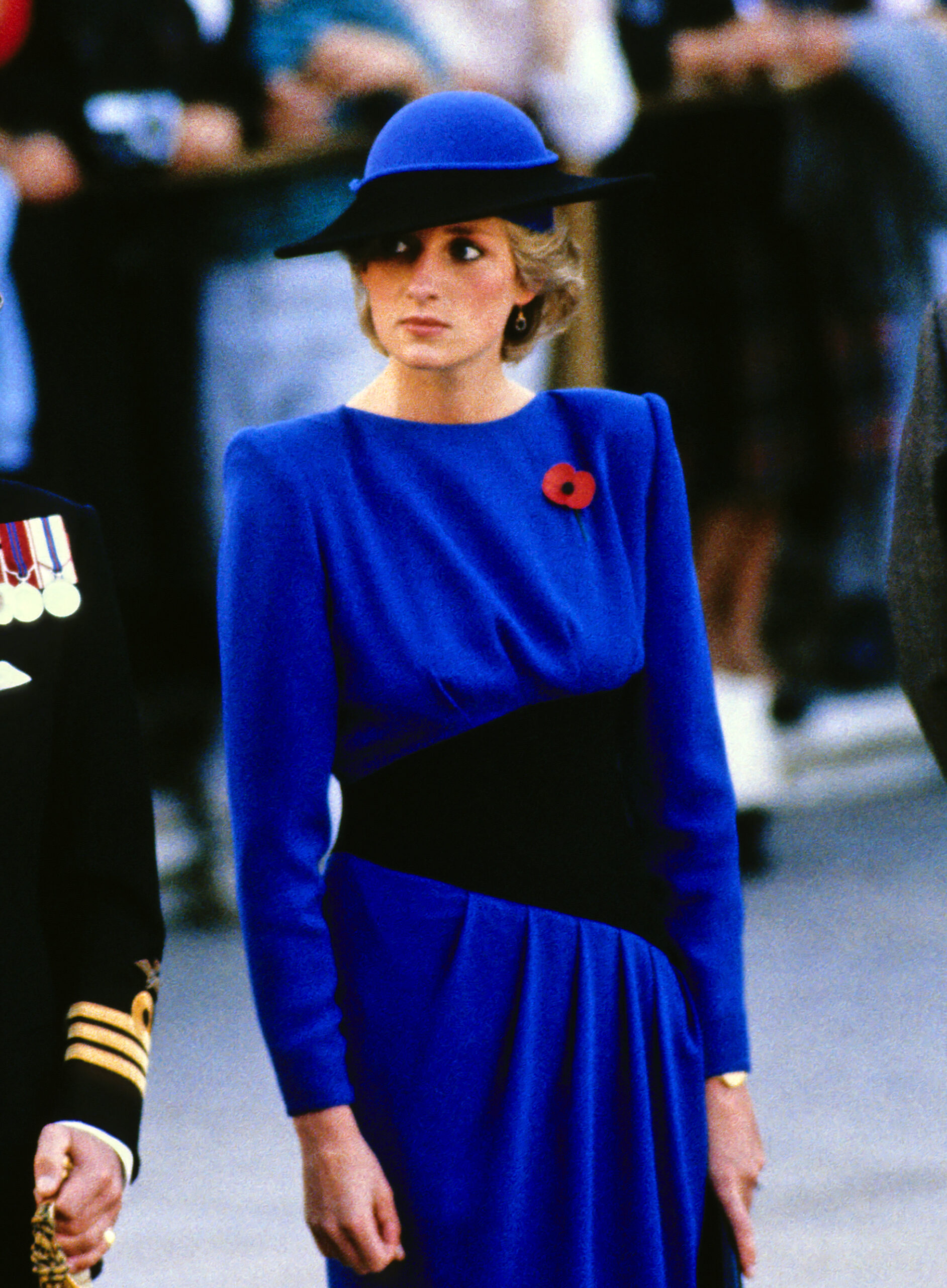 Princess Diana wearing a blue and black dress and matching hat